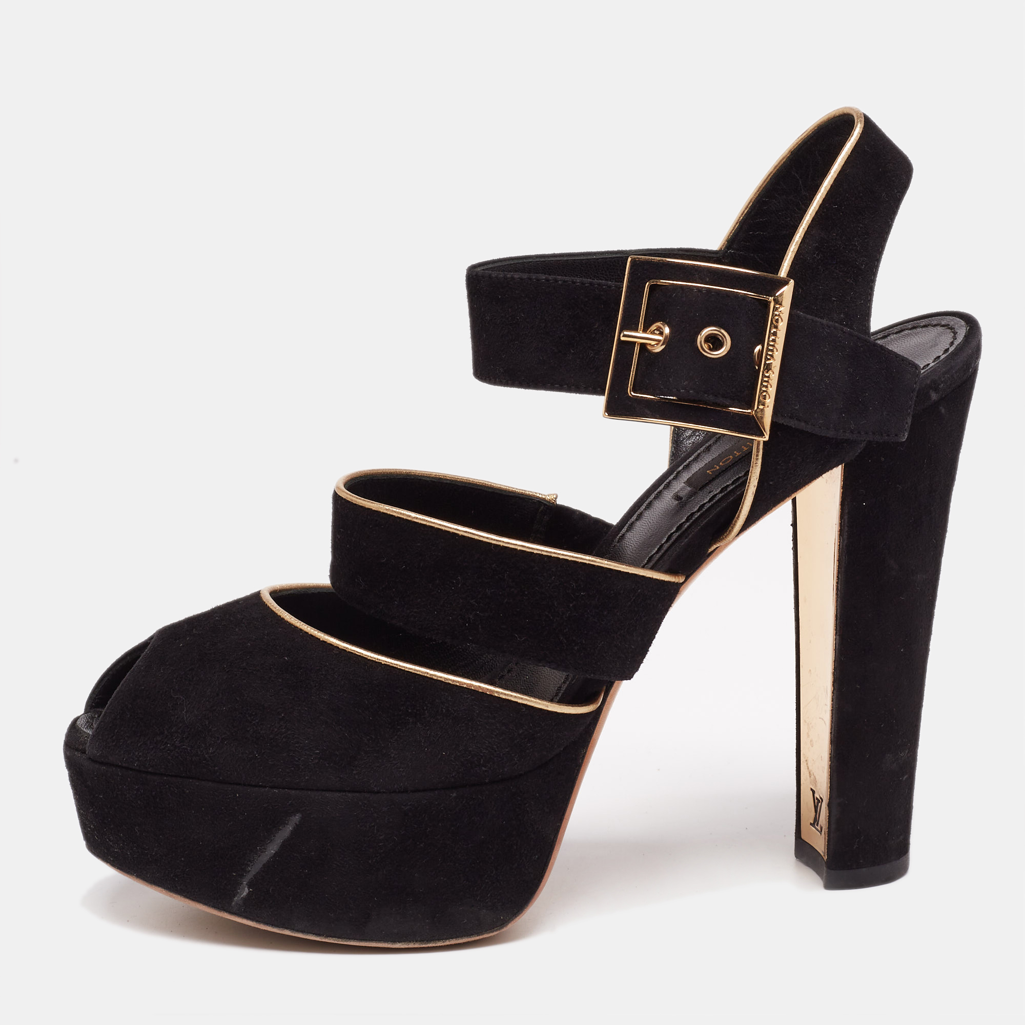 This classy pair of sandals from Louis Vuitton looks even better on the feet. The shoes have a suede exterior added with metallic trims simple buckle closure and open toes. They are lifted on platforms and 12.5 cm heels.