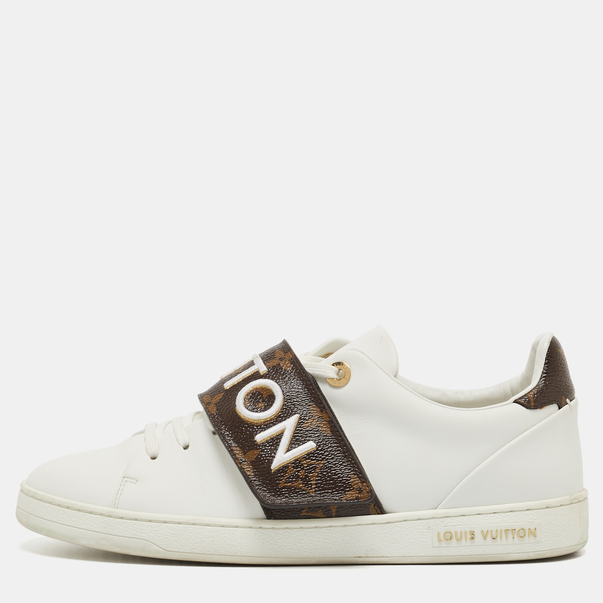 A great way to elevate your casual look these white sneakers from Louis Vuitton feature a contrasting velcro strap over the lace up vamps. The brand name vamps adds a luxe touch to the design.