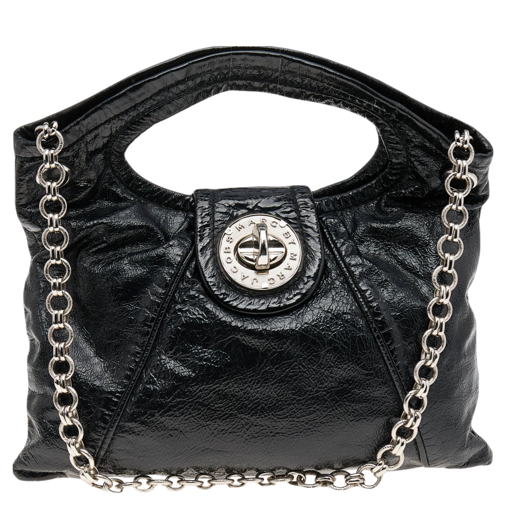 Durably fashionable this Marc by Marc Jacobs design is a timeless accessory. This beautifully made bag has a silver tone metal lock attached handles and a shoulder chain. The fabric lined interior is perfectly sized to house your days essentials.