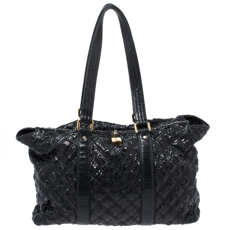 Undisputedly stylish and brilliantly designed this black tote is from Marc Jacobs. Crafted from snakeskin embossed leather the tote features a quilted exterior and a padlock on the front. The canvas lined interior is secured by a zip closure and the bag is held by dual handles.