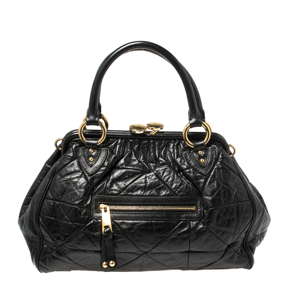 This Marc Jacobs design has a black crinkled exterior crafted from leather and enhanced with gold tone hardware. This elegant Stam bag features a kiss lock top closure that opens to a fabric interior dual top handles and a removable chain that converts this piece between shoulder and hand styles easily. Swing this beauty wherever you go and make heads turn