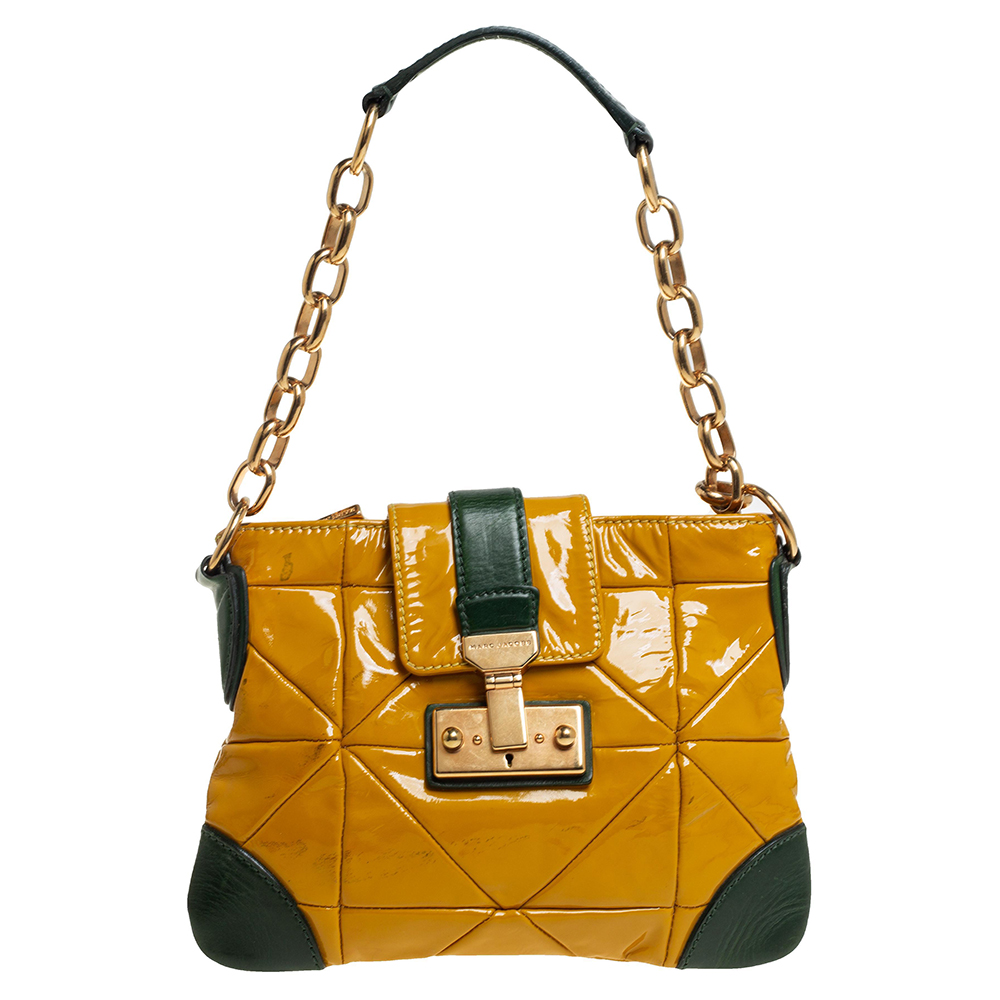 Coming from the house of Marc Jacobs this trendy handbag ensures versatility and style. Presenting a patent leather handbag which is an absolute mixture of fashion and utility. The bag opens up to showcase a fabric lined interior. This yellow bag displays your fashion forward choice when it comes to accessories.