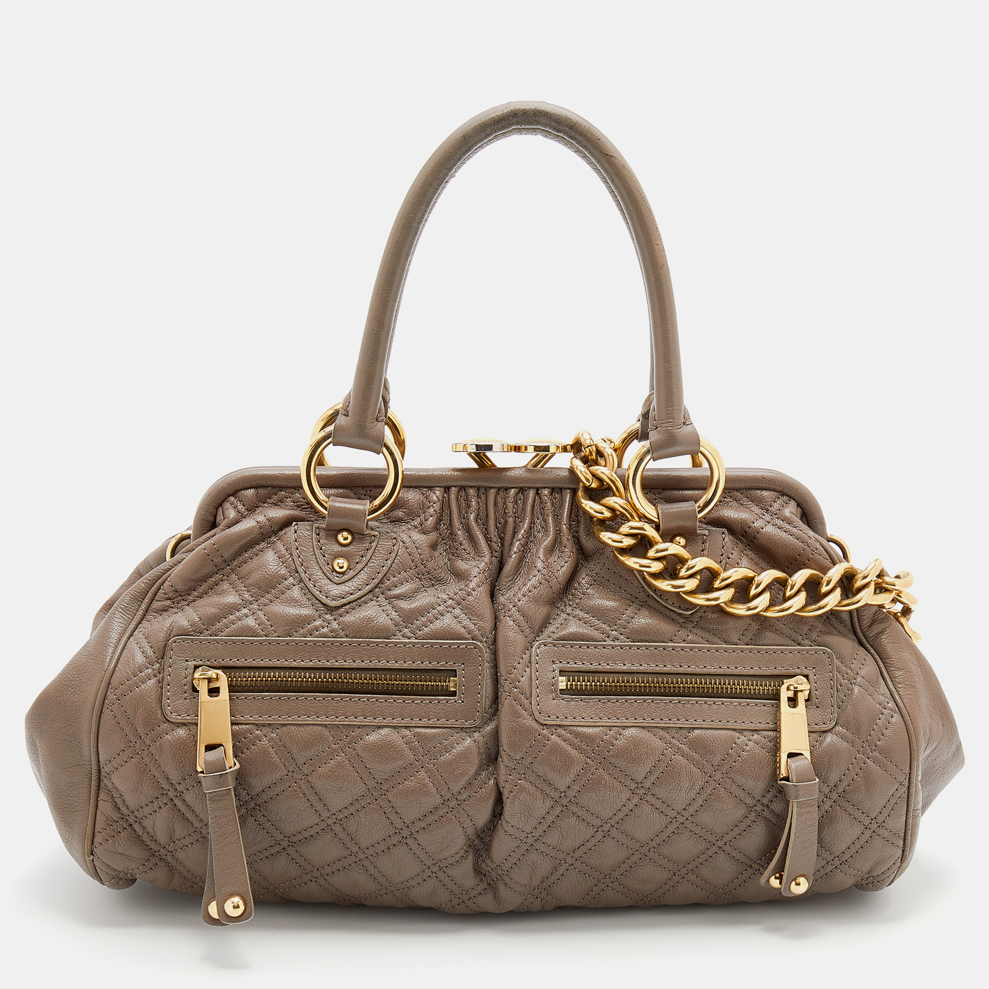 Easy to carry and stylish in appearance this Stam satchel from the House of Marc Jacobs will certainly be your favorite pick this season. It is crafted using grey quilted leather with gold tone hardware elevating its beauty. It provides two handles and a spacious fabric lined interior.