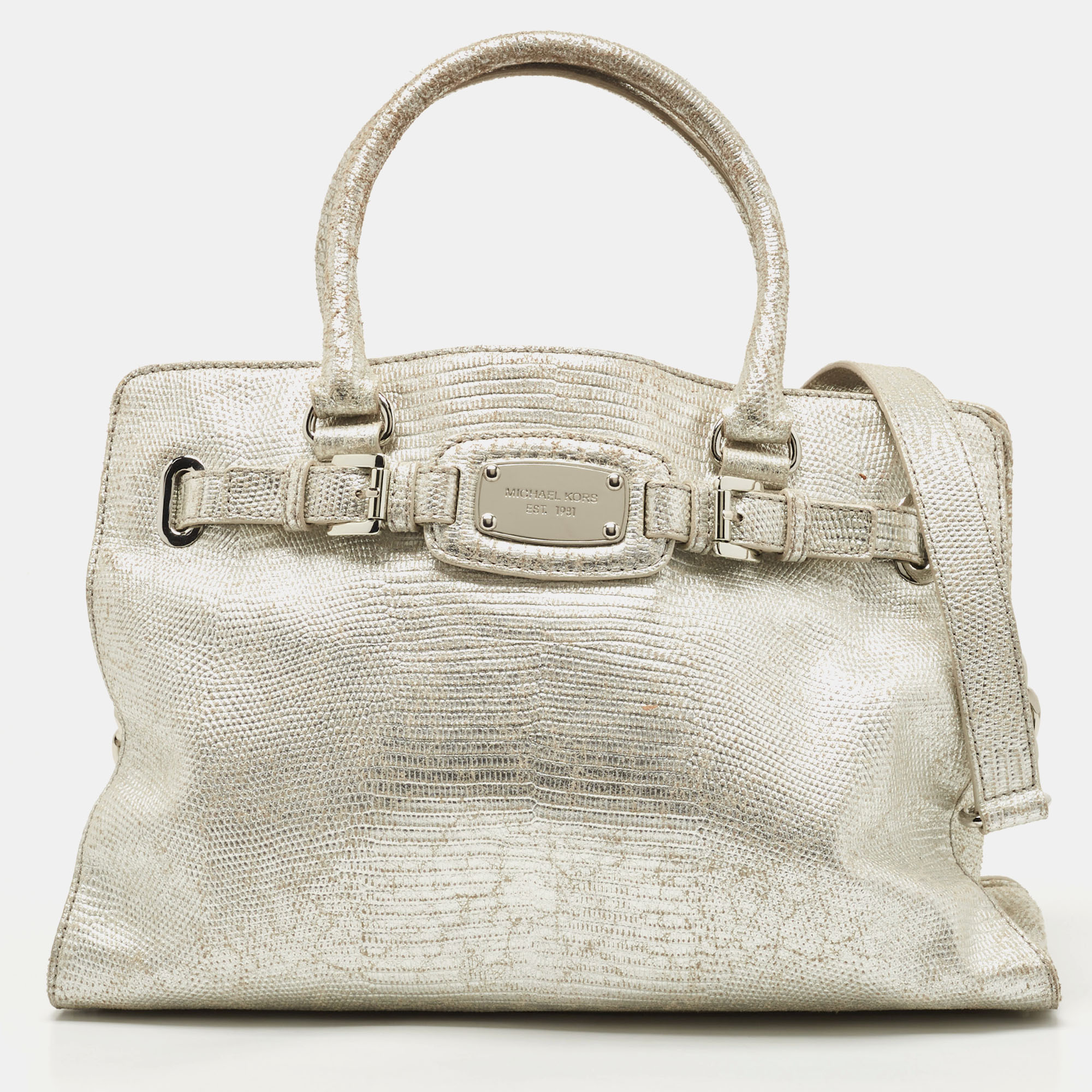This simple Hamilton tote from Michael Kors is a worthy buy. It features dual top handles a shoulder strap protective metal feet and belt detailing on the front. Crafted from silver leather it has a spacious lined interior for all your essentials.
