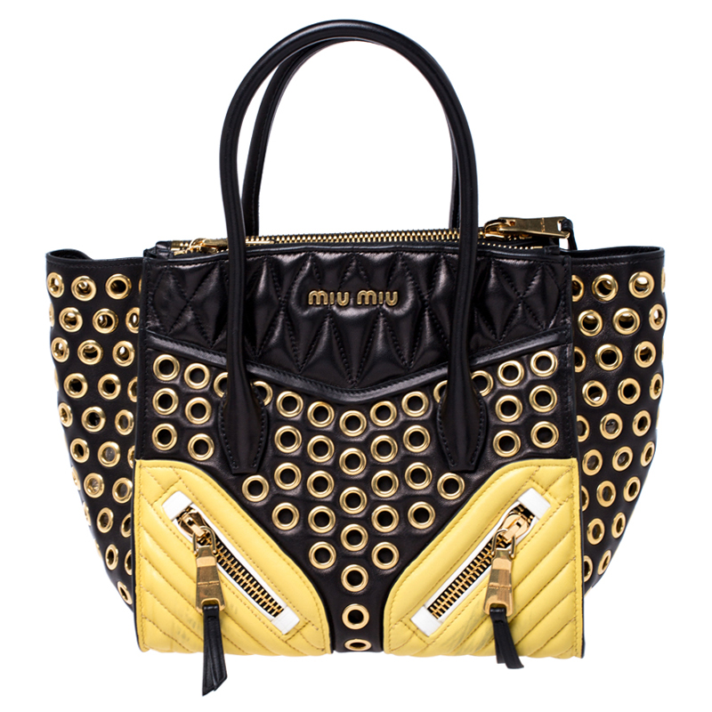 Bold design and exquisite detailing define this biker convertible tote with utter charm. It is crafted from black leather and is fabulously designed with Metalasse detailed gold panels which carry zipper pocket to the front gold tone eyelets all over solid quilted black panels at the top and twin top handles. It boasts of leather satin interior housing zippered compartments and pockets. The tote is complete with studs at the bottom.