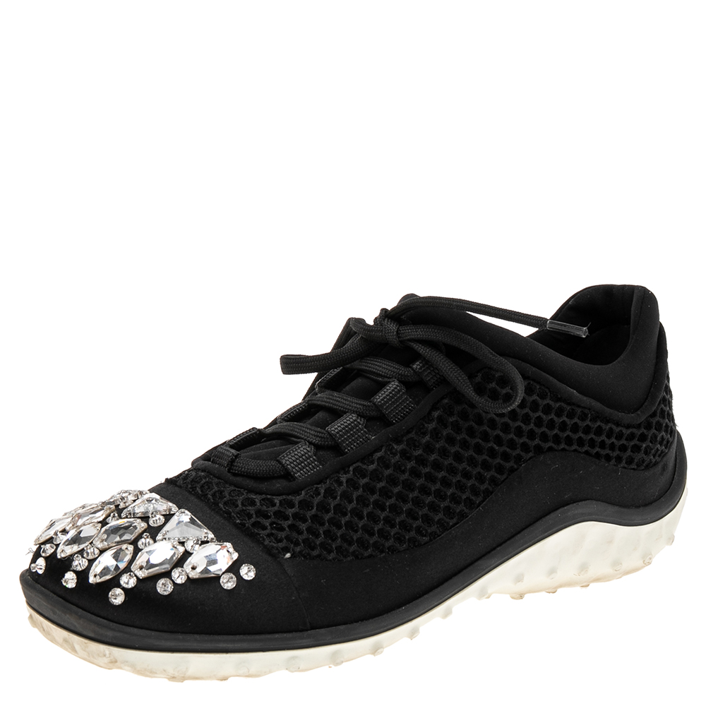A signature Miu Miu style these low top sneakers for women are crafted in mesh as well as satin and detailed with crystals on the cap toes. They are secured with lace ups and set on durable rubber soles.
