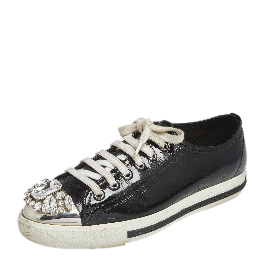 These stunning sneakers from Miu Miu are meant for sneaker lovers like you They have been crafted from black patent leather and designed with crystal embellished toes and lace ups on the vamps. Comfortable and classy these low top sneakers can go well with your casual outfit.