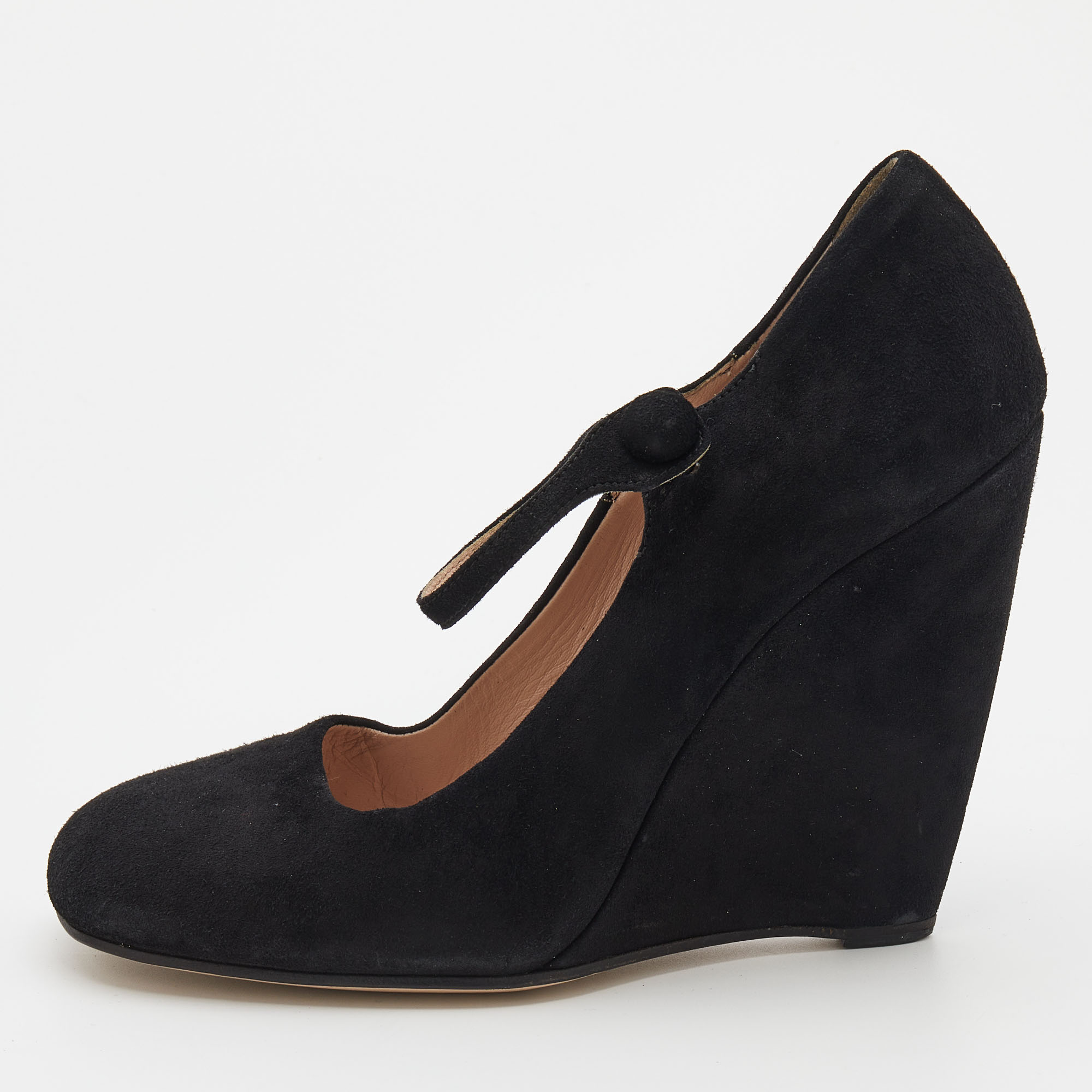 These pumps from Miu Miu are designed to bring comfort and style at the same time. They are made from black suede and added with square toes Mary Jane ankle straps leather lining and wedge heels.