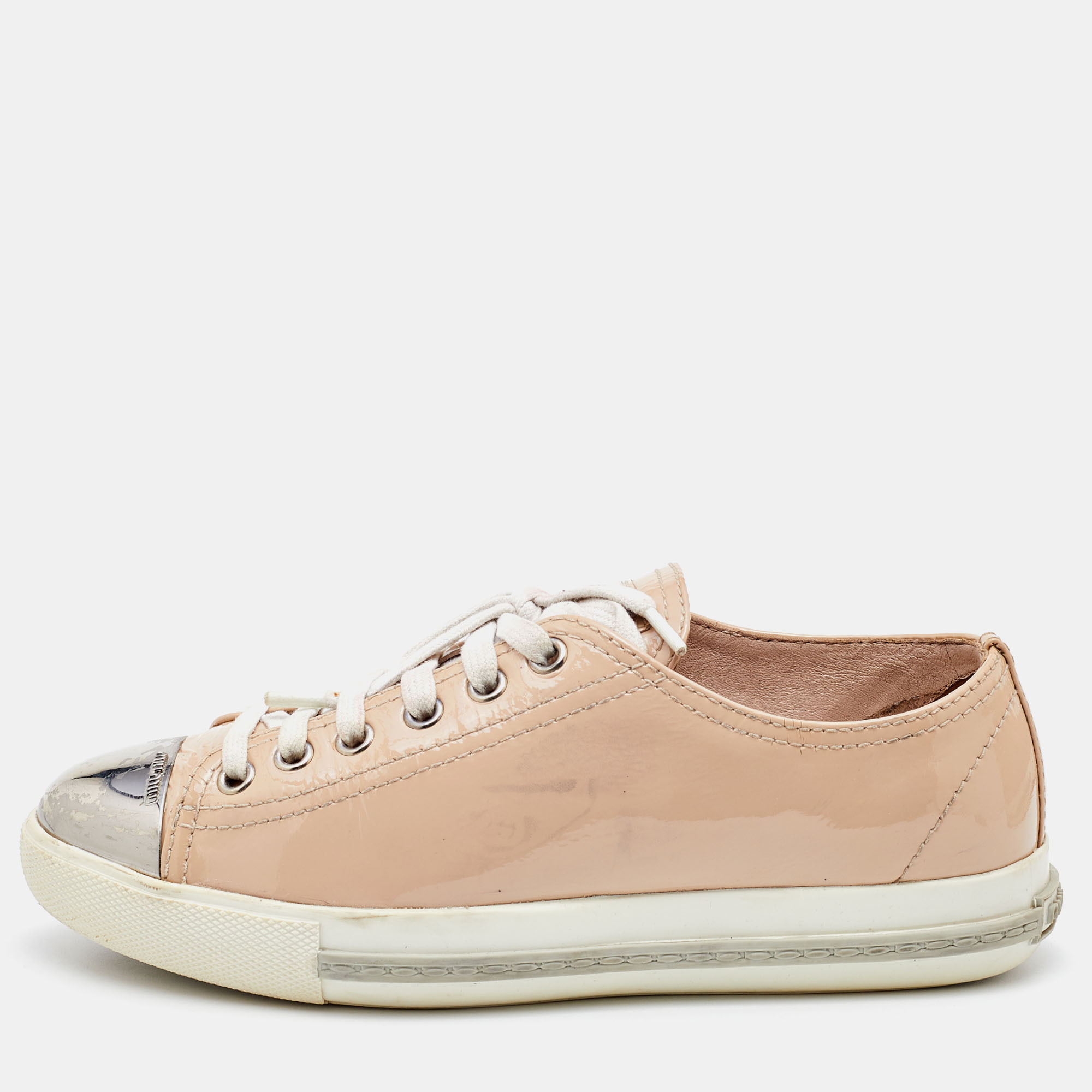 A signature Miu Miu style these low top sneakers for women are crafted in patent leather and detailed with metal hardware on the cap toes. They are secured with lace ups and set on durable rubber soles.