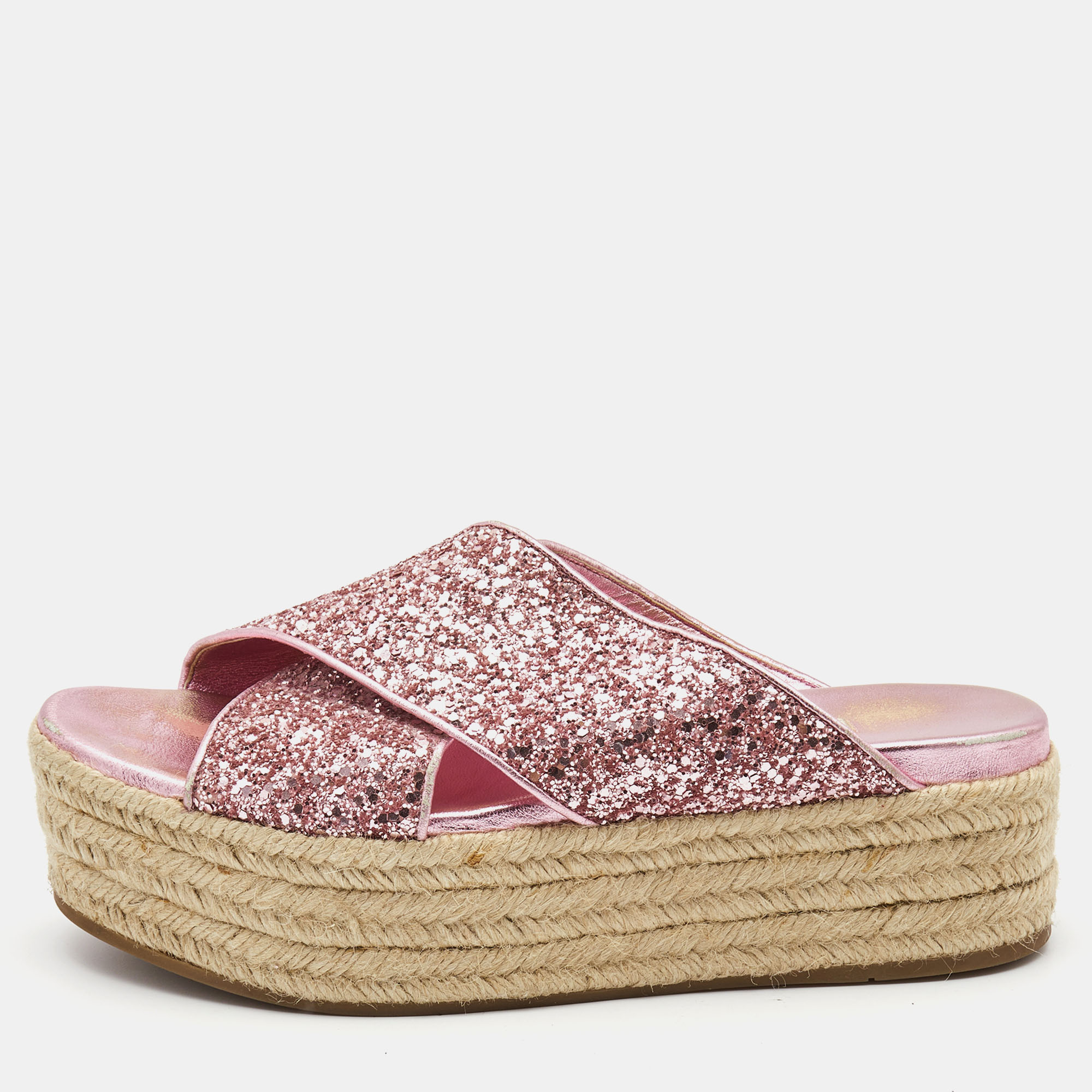 Miu Miu is well known for graceful designs and the label is synonymous with opulence femininity and elegance. Designed into a chunky silhouette these sandals have crisscrossed straps covered with glitter and thick espadrille platforms.
