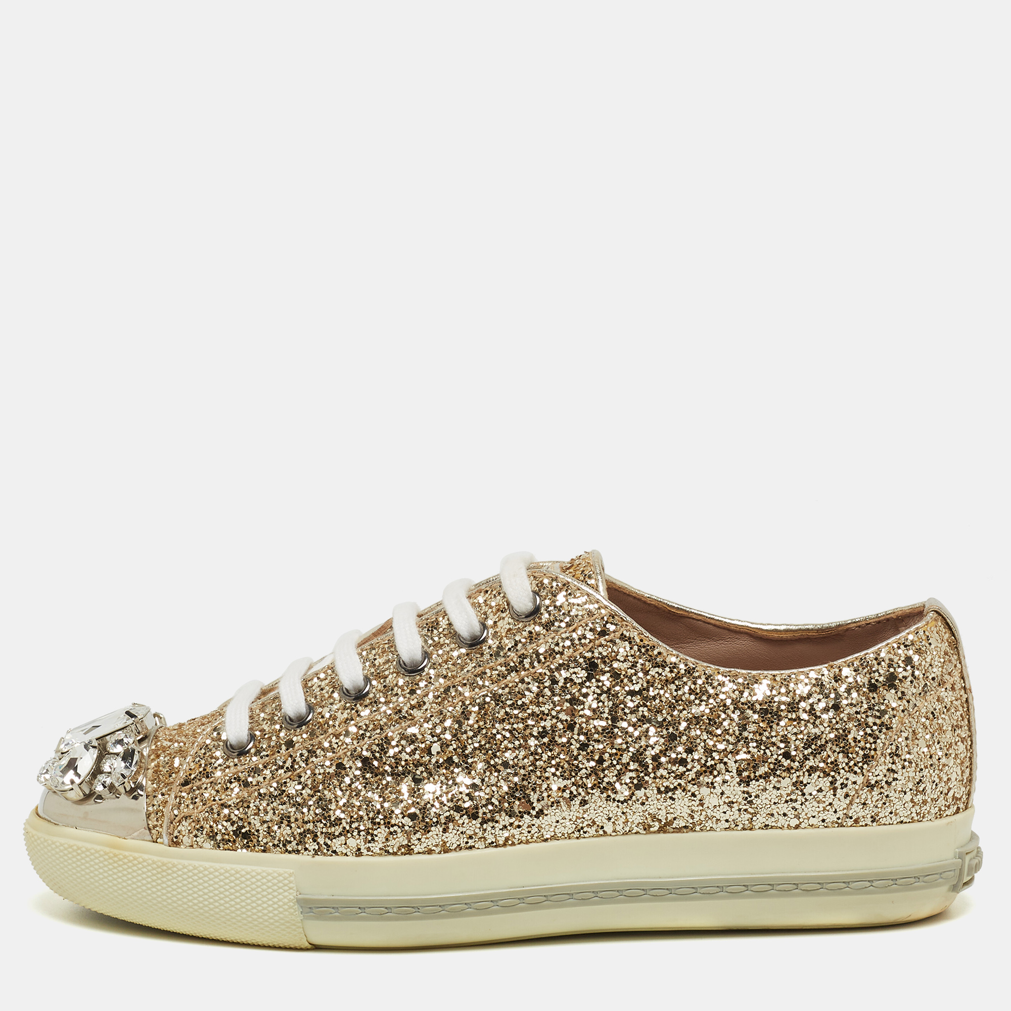 A signature Miu Miu style these low top sneakers for women are crafted in glitter and detailed with crystals on the cap toes. They are secured with lace ups and set on durable rubber soles.