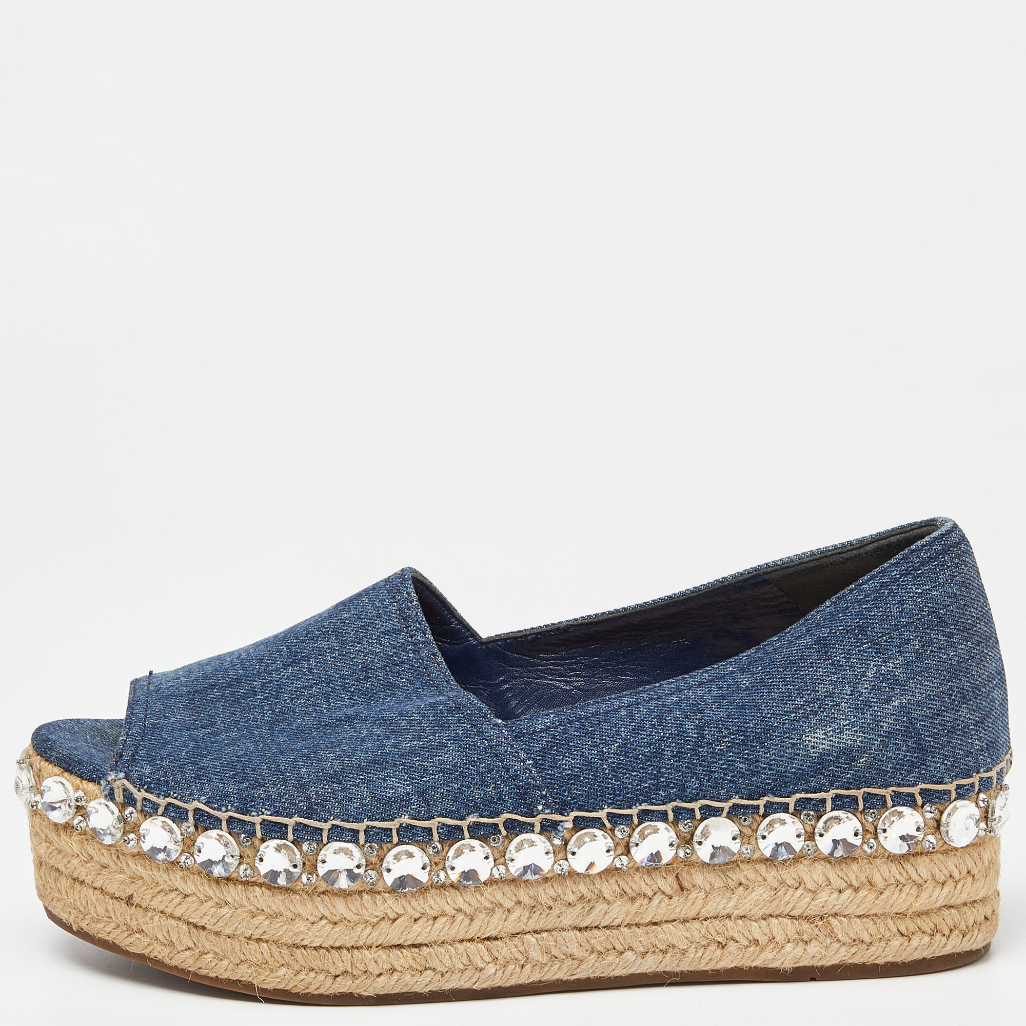Espadrilles are not just stylish but also comfy and easy to wear. This lovely pair of Miu Miu espadrilles will accompany a casual outfit with perfection. They are made of denim and designed with leather insoles open toes and braided platforms.