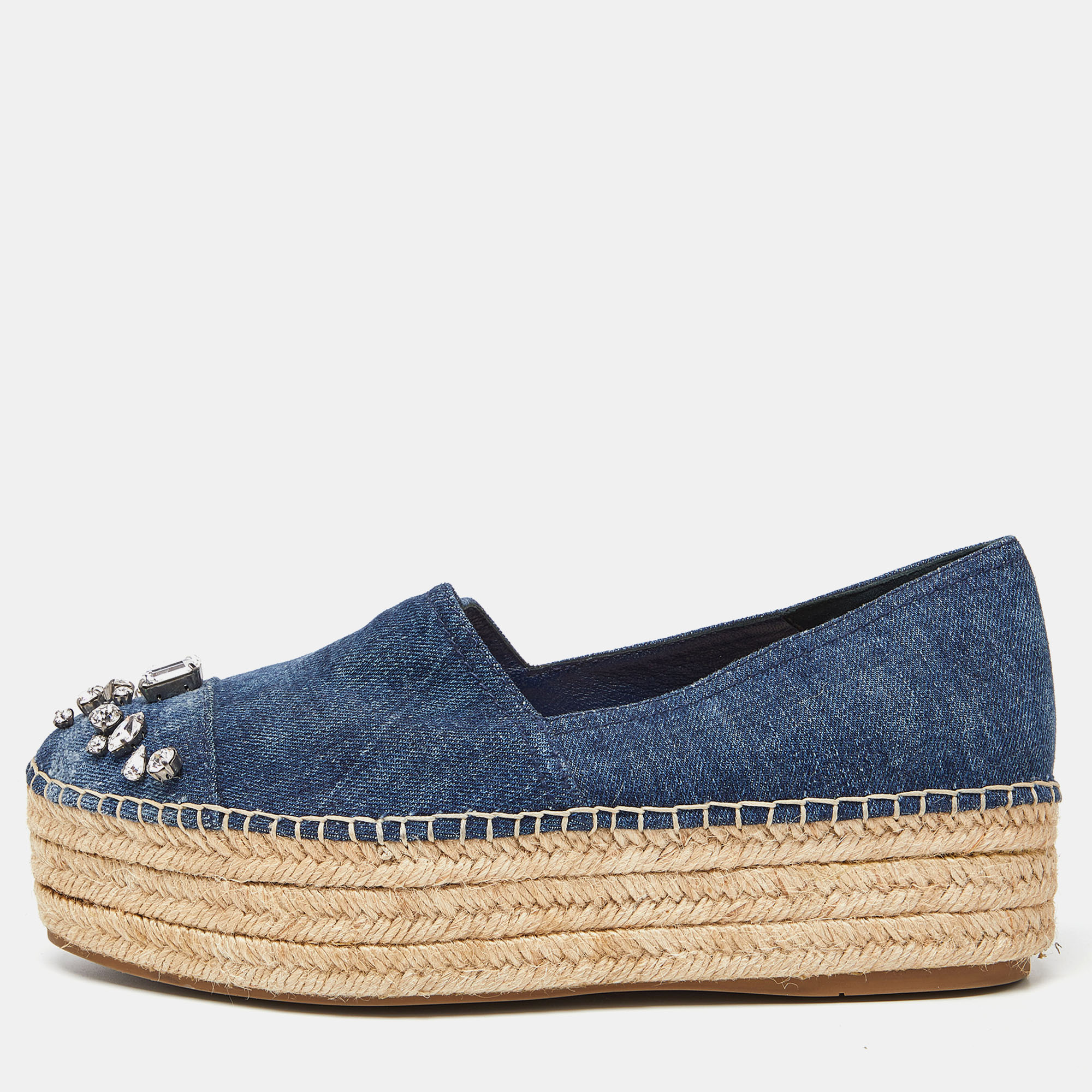 Espadrilles are not just stylish but also comfy and easy to wear. This lovely pair of Miu Miu espadrilles will accompany a casual outfit to perfection. The blue shoes are made of denim and designed with sturdy braided platforms as well as crystal embellishments on the cap toes.
