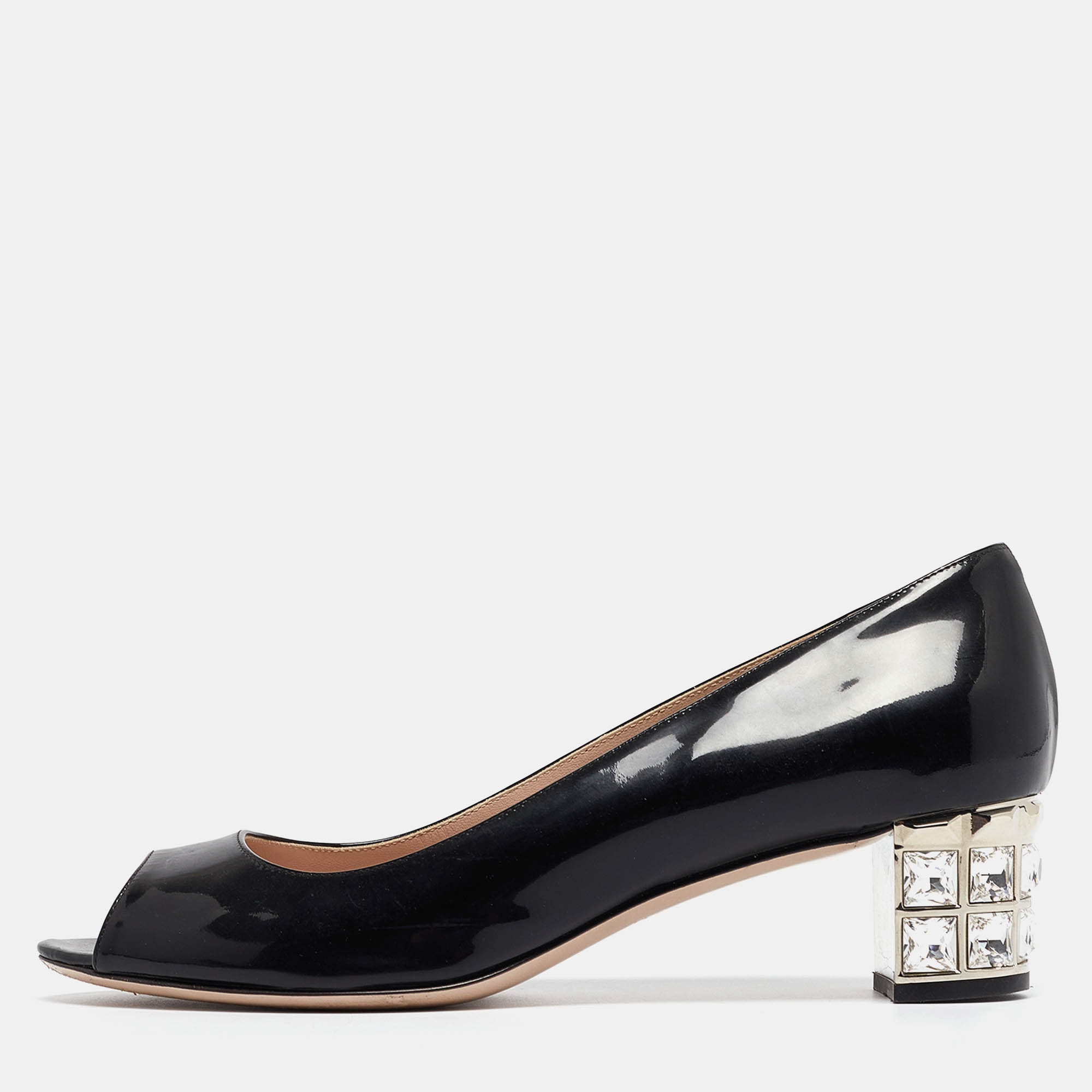 Miu Miu brings to you these lovely pumps to complement your fashionable ensembles. These black pumps are crafted from patent leather and feature crystal embellished block heels. They flaunt peep toes and come endowed with comfortable leather lined insoles.