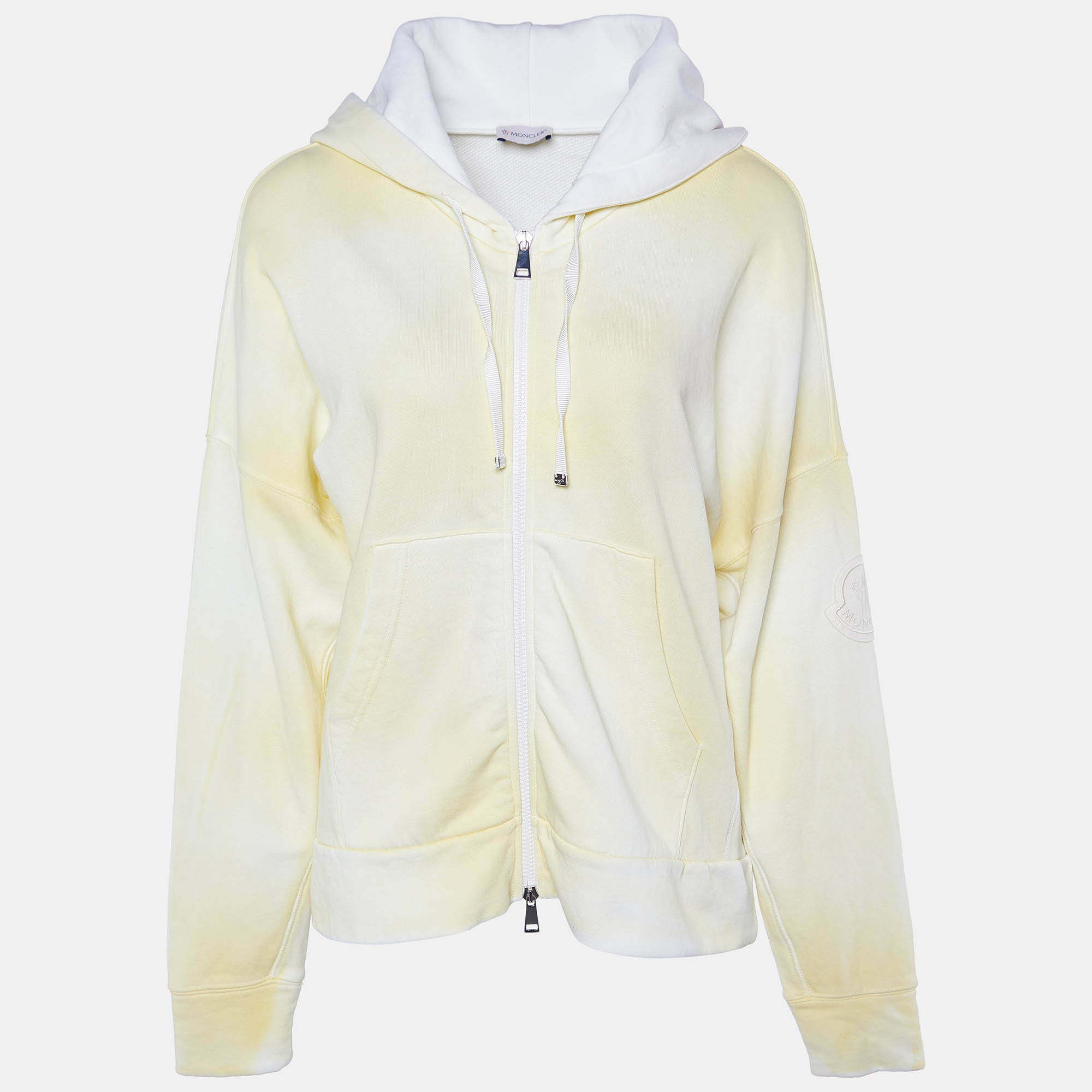 Indulge in vibrant luxury with the Moncler cardigan. Crafted from premium cotton its sunny hue and tie dye motif evoke a sense of playful sophistication. The zip up design and cozy hood offer both style and comfort making it a standout addition to any wardrobe.