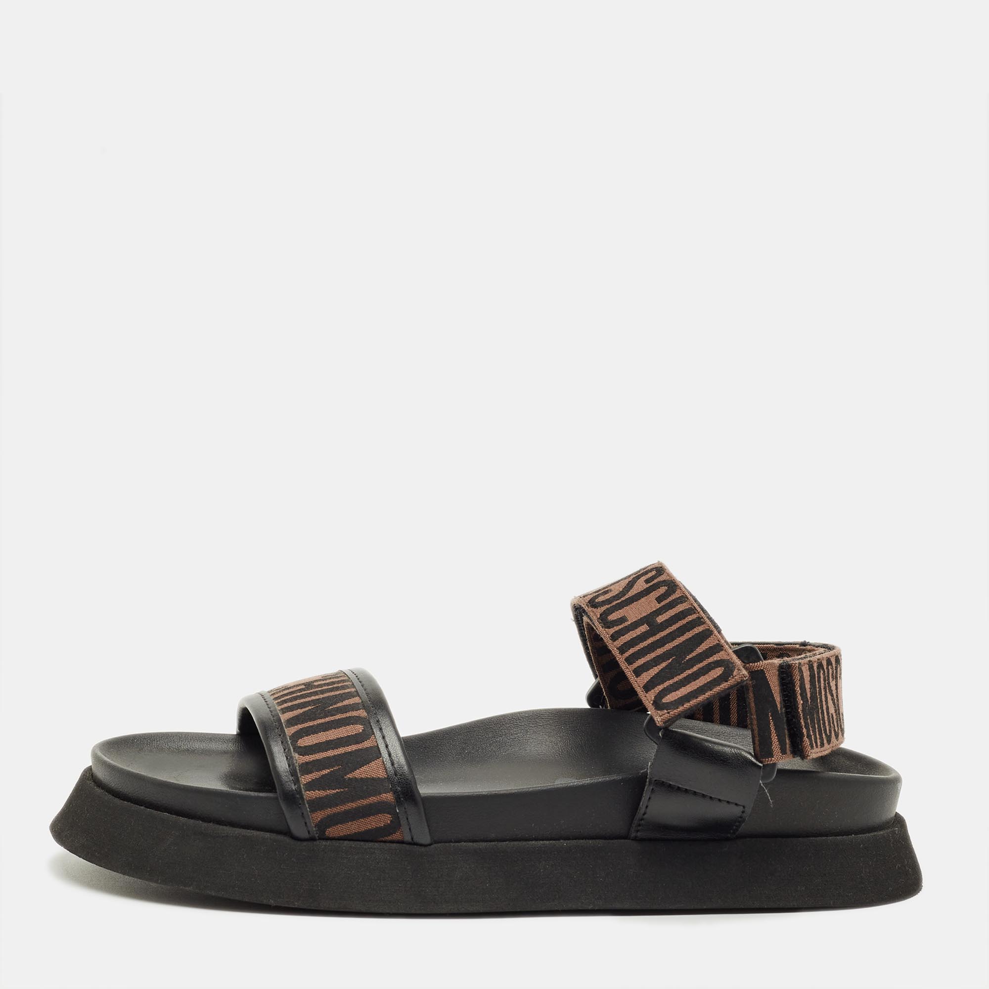 Pre-owned Moschino Brown/black Canvas Logo Ankle Strap Flat Sandals Size 37