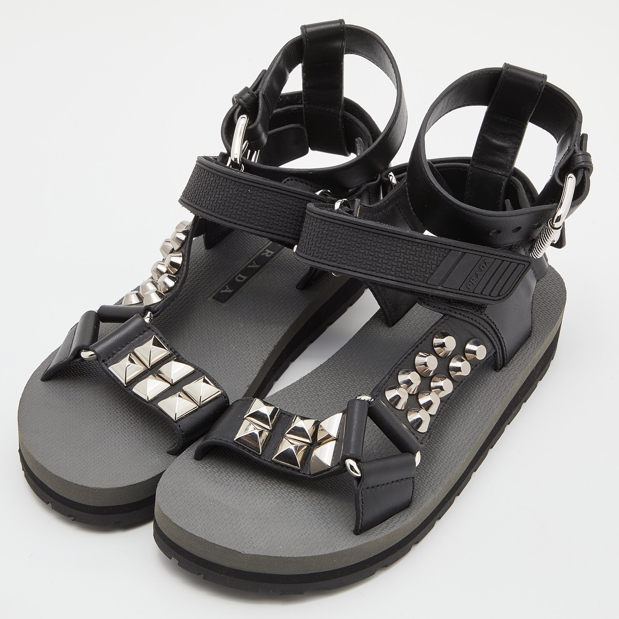 

Prada Black Leather and Rubber Punk Stud Ankle Strap Flat Sandals Size