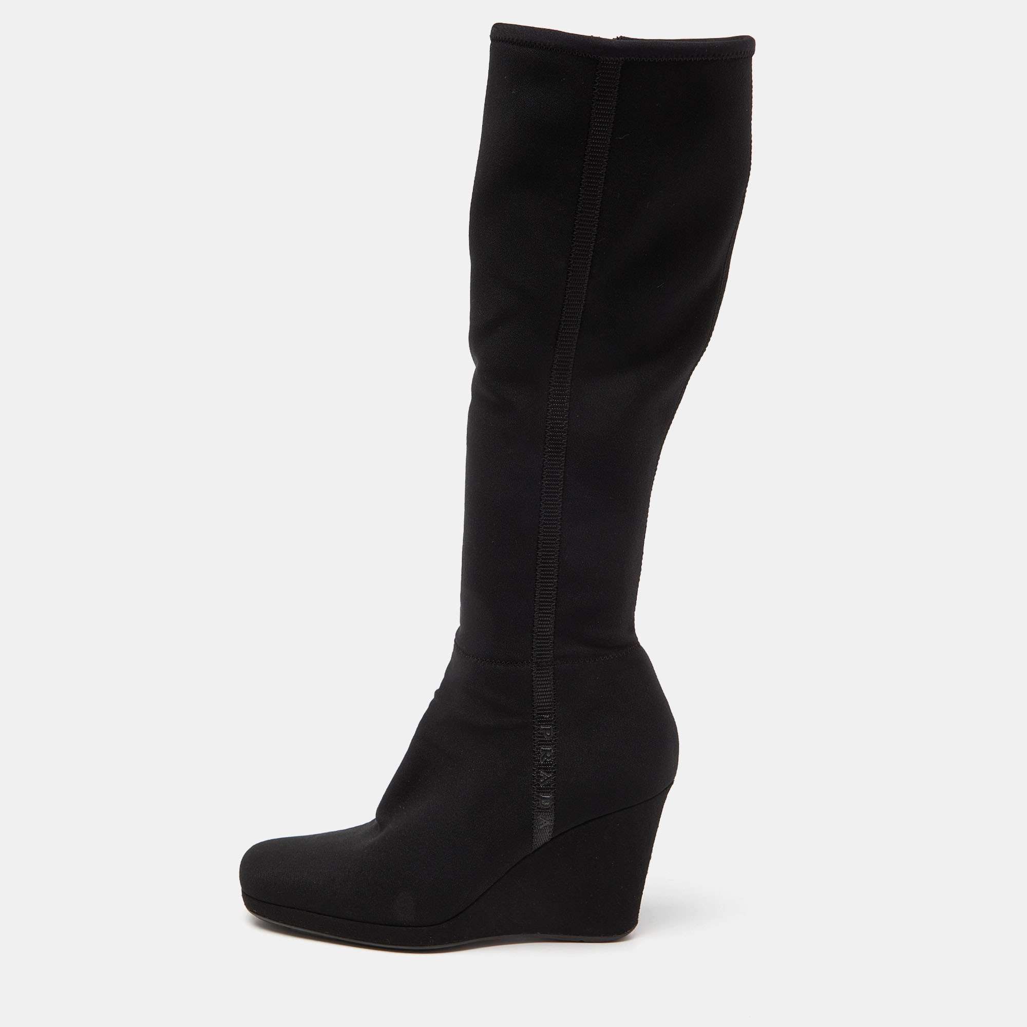 This pair of boots from Prada Sport is high in both fashion and comfort. Crafted from black quality materials they bring round toes side zippers and 9cm wedges. These ankle boots are highly durable and stylish.