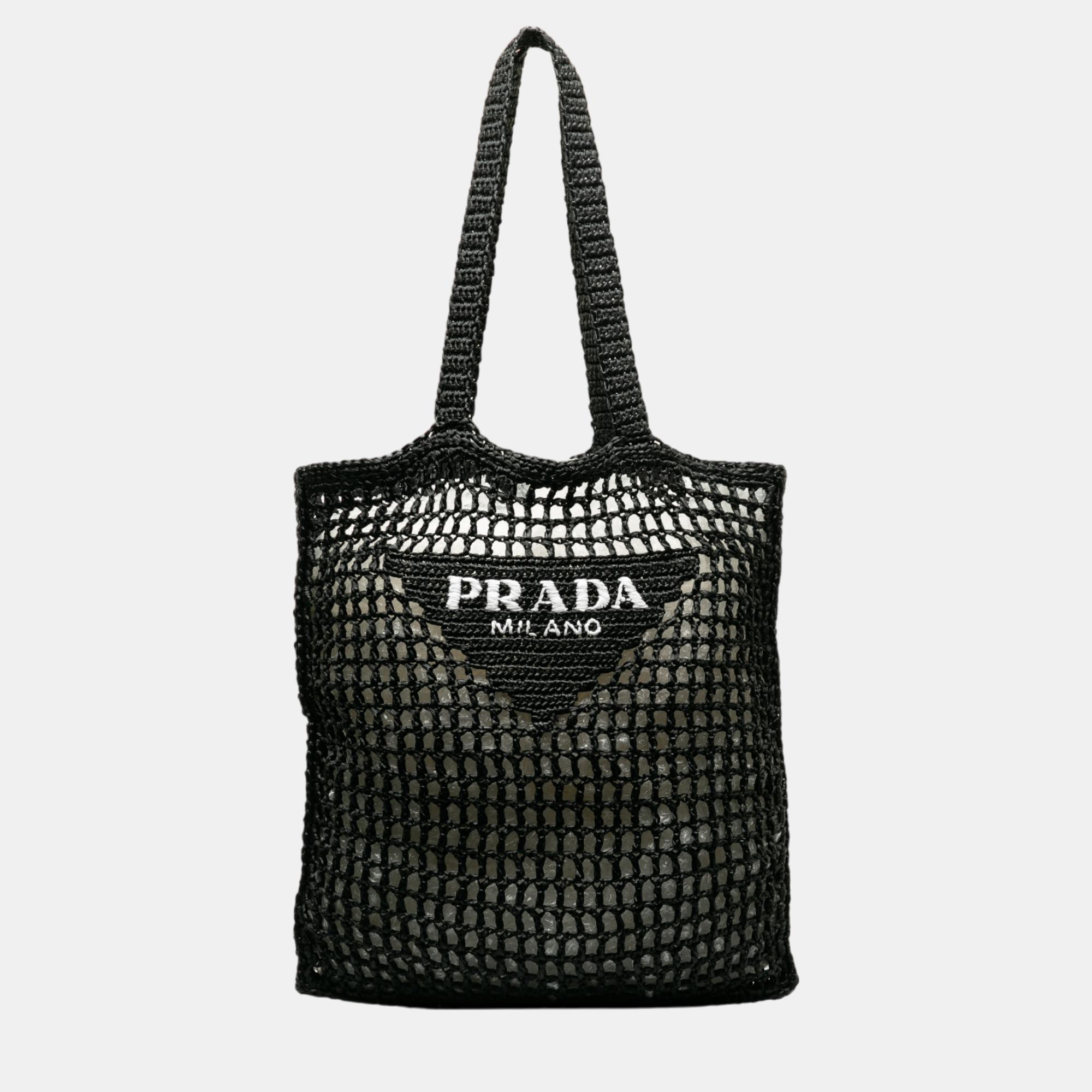 This tote bag features a woven raffia body flat raffia handles and an open top.