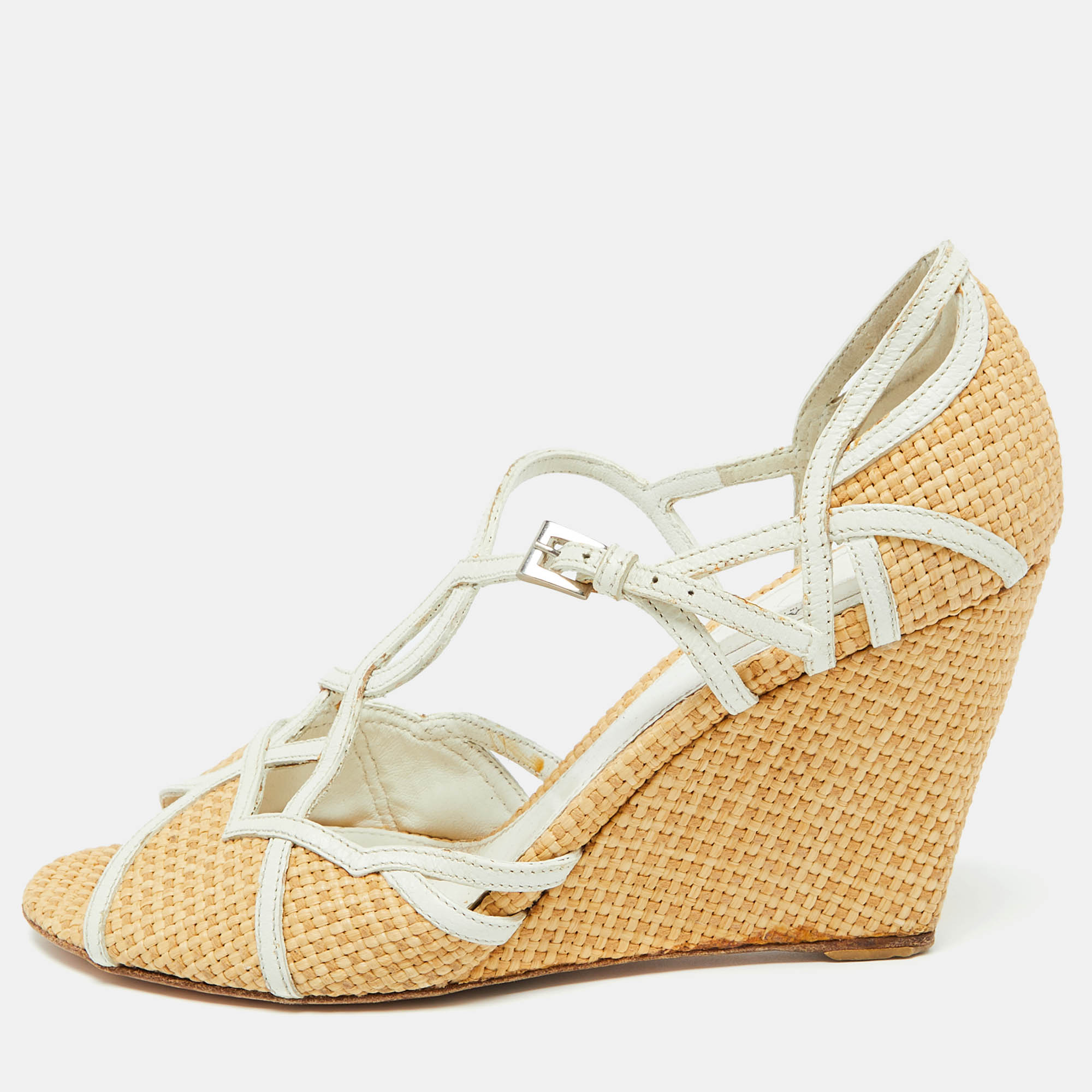 Pradas wedge sandals will be a go to pair as theyre perfect to wear for long hours with flowy dresses to tailored co ord sets. The shoes have woven leather upper matched and complemented beautifully by a wicker platform wedge heel thus creating a harmonious result.