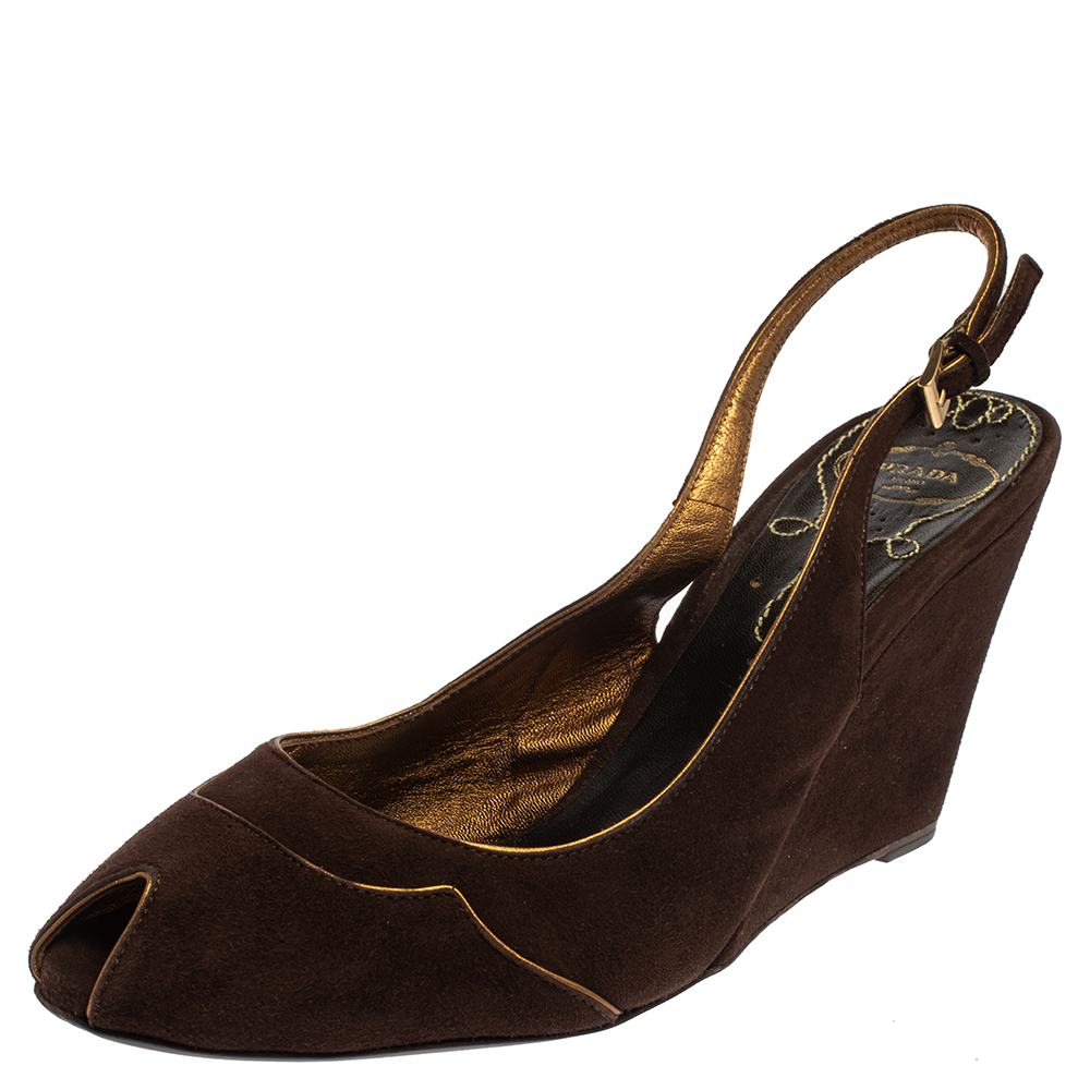 Made in a chic classy design these Prada sandals are made from brown suede. They are adorned with peep toes secured with ankle straps and elevated on comfortable wedge heels.