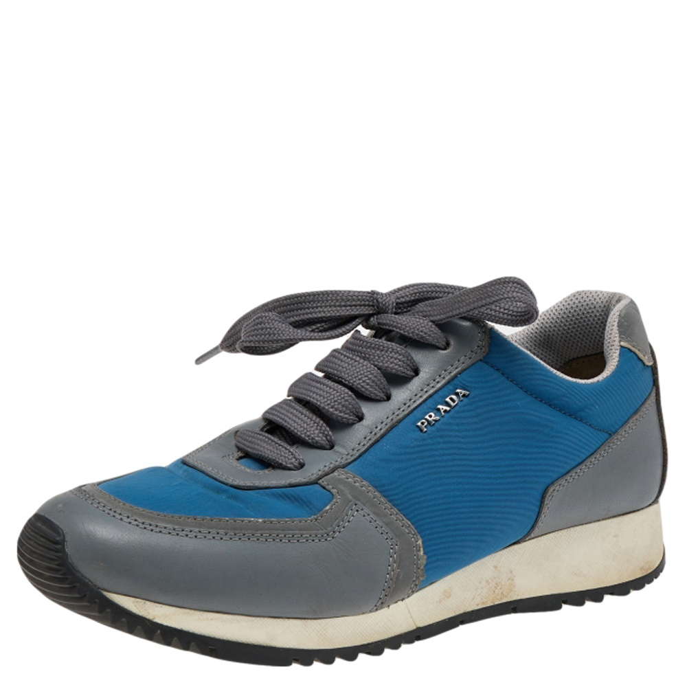 Coming in a classic low top silhouette these Prada Sport sneakers are a seamless combination of luxury comfort and style. They are made from nylon and suede in grey and blue shade. These sneakers are designed with logo details laced up vamps and comfortable insoles.