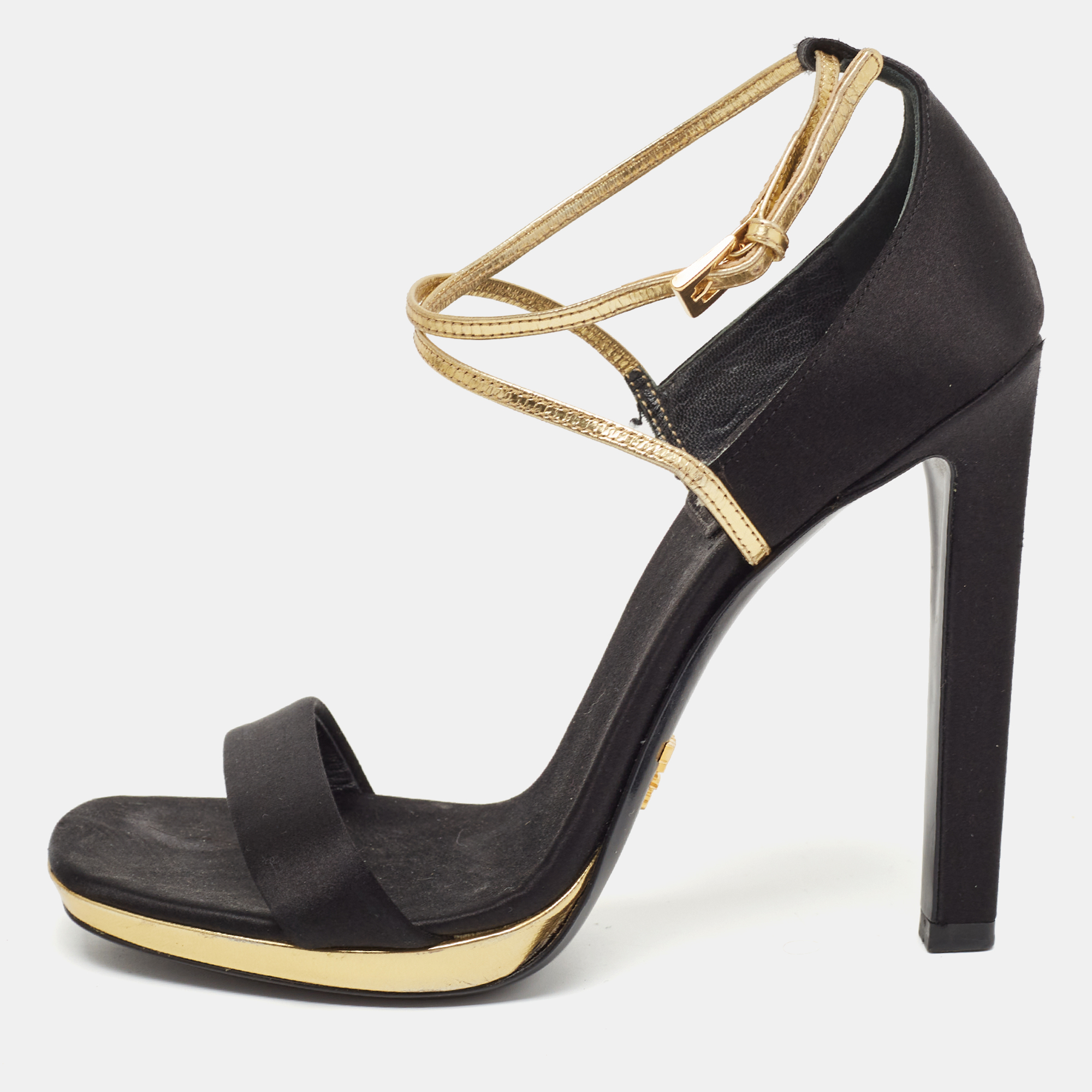 These modish Prada sandals will elevate you and your outfit with ease. Crafted from black satin they come with gold leather criss cross straps and buckle fastenings. Theyre set on 13cm heels.
