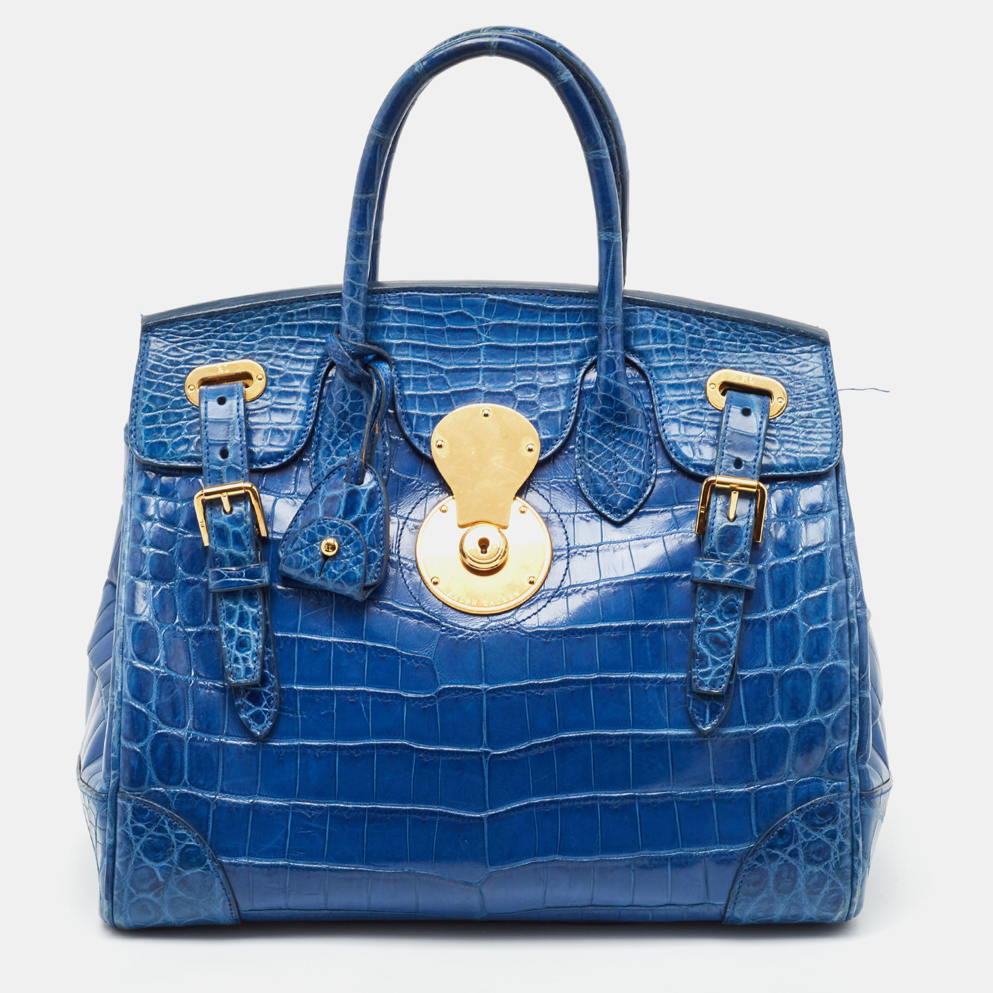 Classy in shape and design this Ricky 33 tote by Ralph Lauren will be a loved addition to your closet. It has been crafted from crocodile leather and styled minimally with gold tone hardware. It comes with two top handles and a leather lined interior.