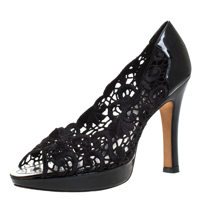These stunning pumps by René Caovilla are the epitome of sophistication. Crafted in Italy they are made from intricate lace and patent leather. They come in a classic shade of black and will complement a hot of outfits. They are styled with peep toes small bow detailing on the uppers platforms and 11.5 cm heels. They are finished with leather lining insoles and soles.