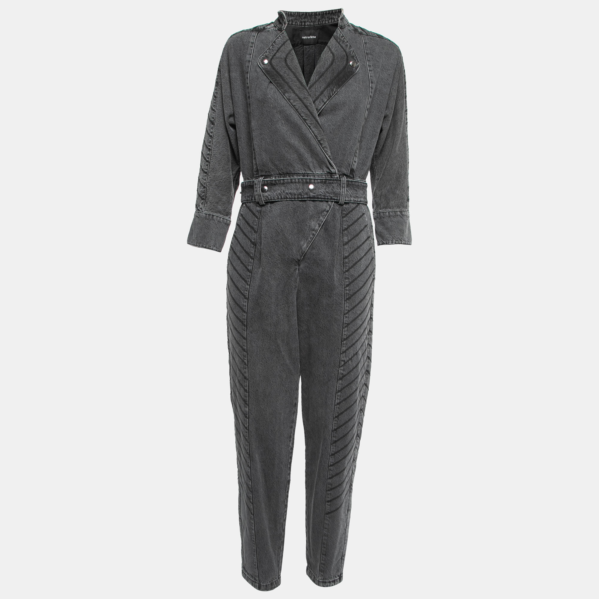The Retrofête jumpsuit exudes vintage charm with its faded grey distressed denim. The one piece features a flattering belted waist combining style and comfort. Its retro flair combined with modern tailoring makes it a versatile and trendy fashion statement for any occasion.