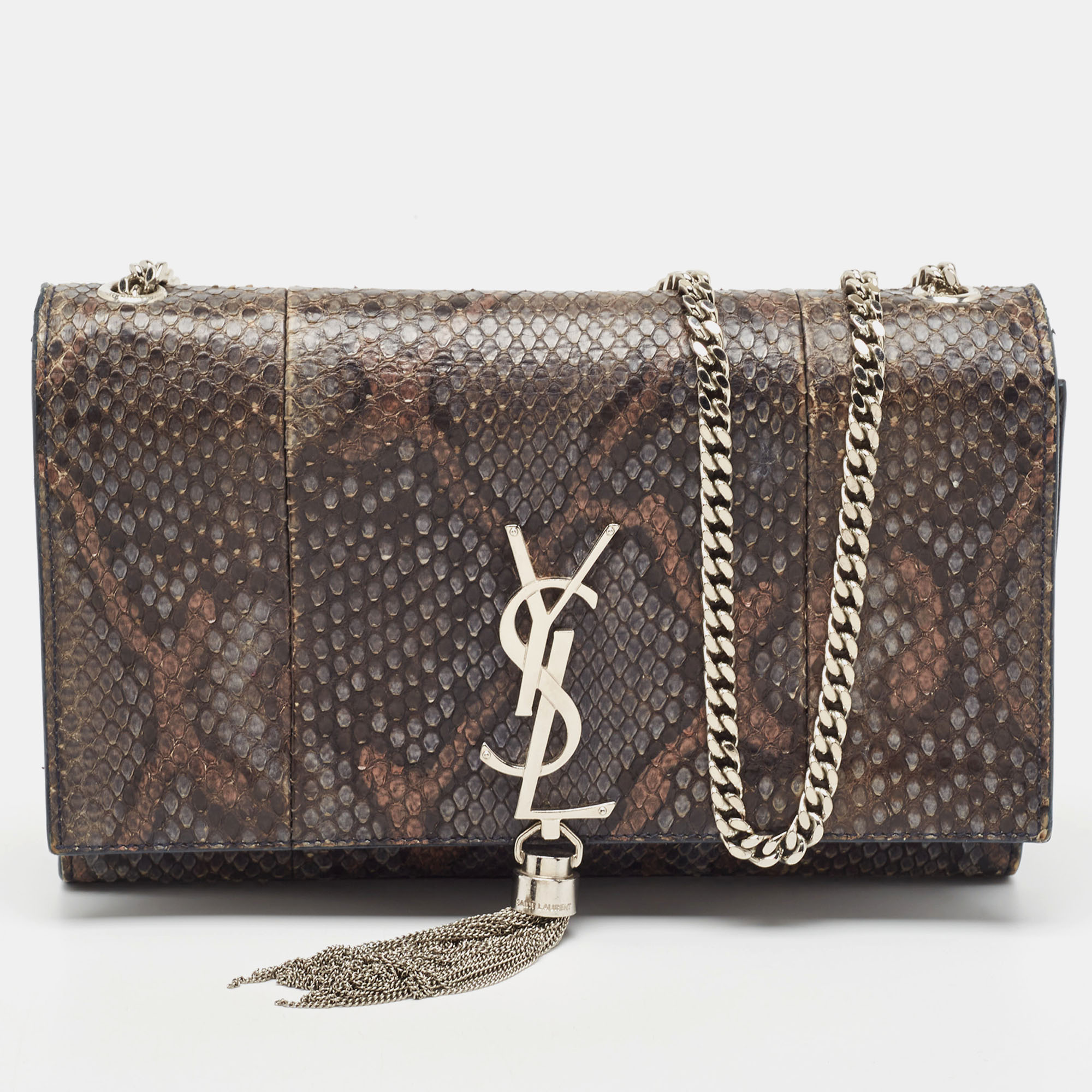 Meticulously crafted from python leather this Saint Laurent Kate bag exudes just the right amount of sophistication. The bag features a sturdy silver tone shoulder chain the YSL logo with a tassel on the front flap and a leather lined compartment to store all your essentials. Carry this stunner wherever you go and make heads turn