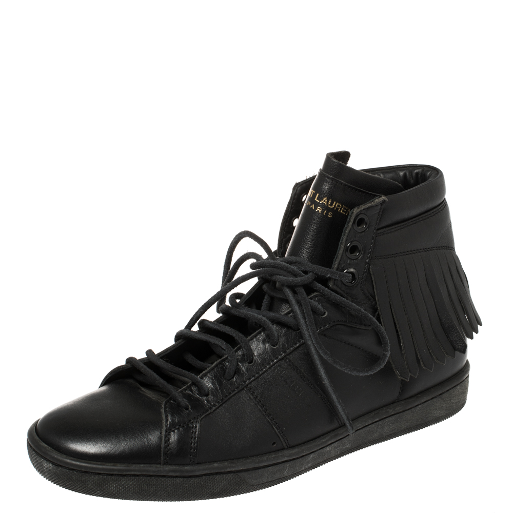 Comfort and style come together in these stylish Classic Court sneakers from Saint Laurent. These have been crafted from black leather in a high top silhouette and designed with round toes lace ups on the vamps logo details on the exaggerated tongues fringes on the counters and durable rubber soles. Wear them for an effortlessly chic look