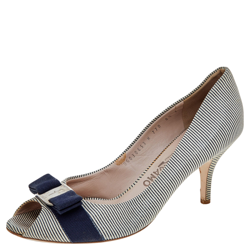 From the house of Salvatore Ferragamo these pumps are tastefully designed. This classic pair in the striped canvas will match well with almost all your outfits. The white blue pumps feature the iconic Vara bows peep toes 7.5 cm heels and comfortable leather lined insoles.