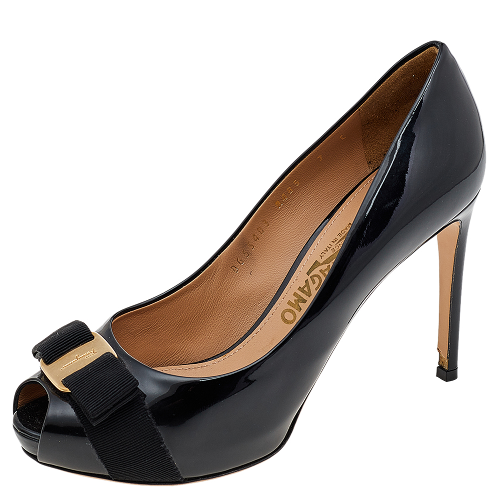 These Salvatore Ferragamo pumps blend comfort and style perfectly The black pumps are crafted from patent leather into a peep toe silhouette. They flaunt a notable Vara Bow on the vamps and are elevated on slim heels.