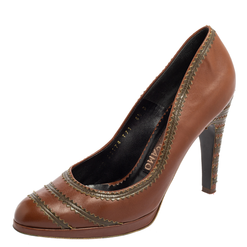Add a luxe edge to your attire by wearing these pumps from the House of Salvatore Ferragamo. They are made from brown leather. They display sturdy heels platforms and a slip on style. These pumps are truly a classy creation you can add to your collection