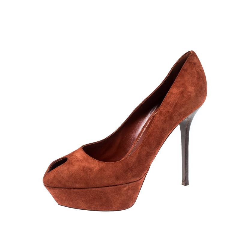 Put your best foot forward wherever you go in these pretty Sergio Rossi pumps. Theyve been crafted from dark orange suede and designed with small peep toes. Supporting platforms and 12.5 cm heels beautifully complete the pair. These pumps are sure to attract admirers