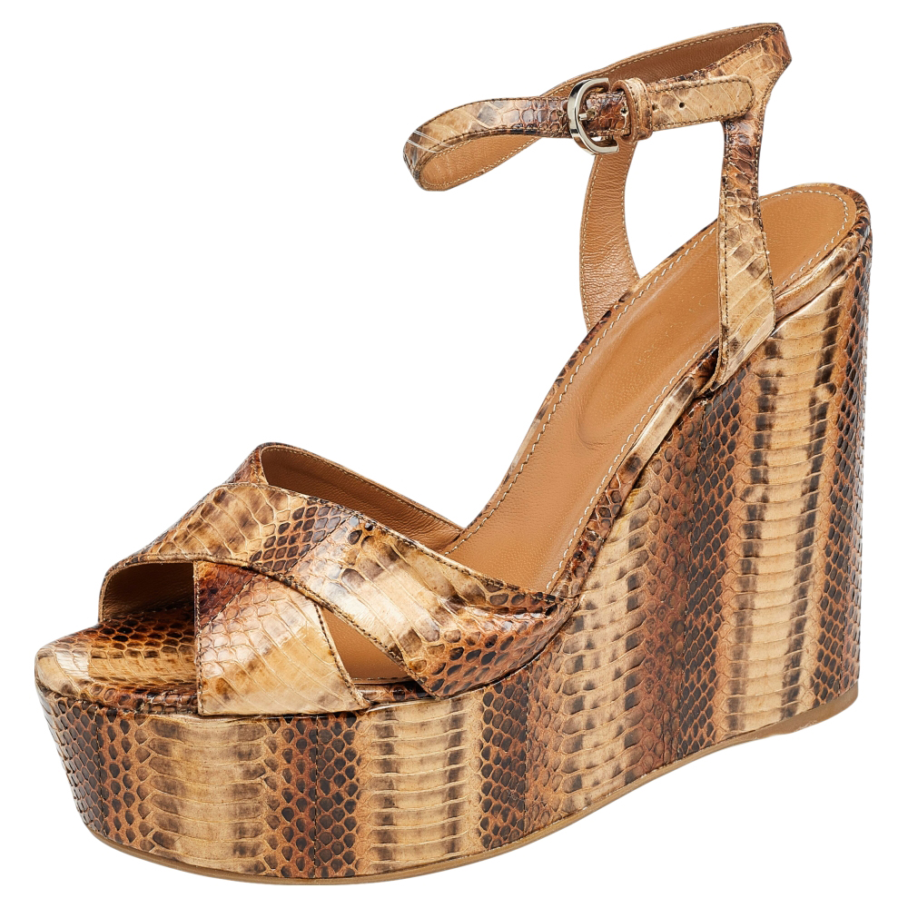 These sandals from Sergio Rossi will lend a stylish edge to your feet. Made from snakeskin they feature open toes buckle detail on the ankle straps and wedge heels. The pair will look great with both dresses and pants.