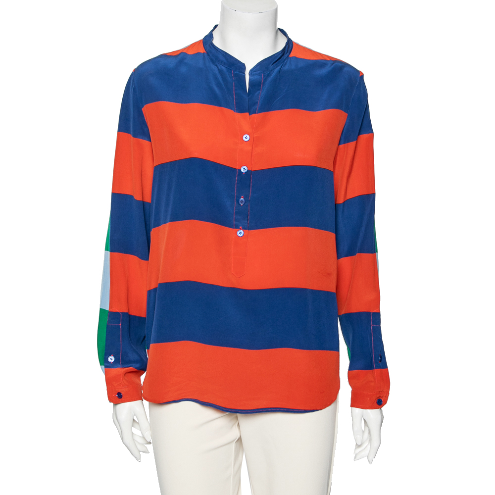 With a radiant vibe this Stella Mc Cartney shirt will ward off the gloom. It is made from silk and features a mandarin style neckline long sleeves with a buttoned cuff and front button fastenings. The combination of two different color stripes at its back and front makes the design more appealing.