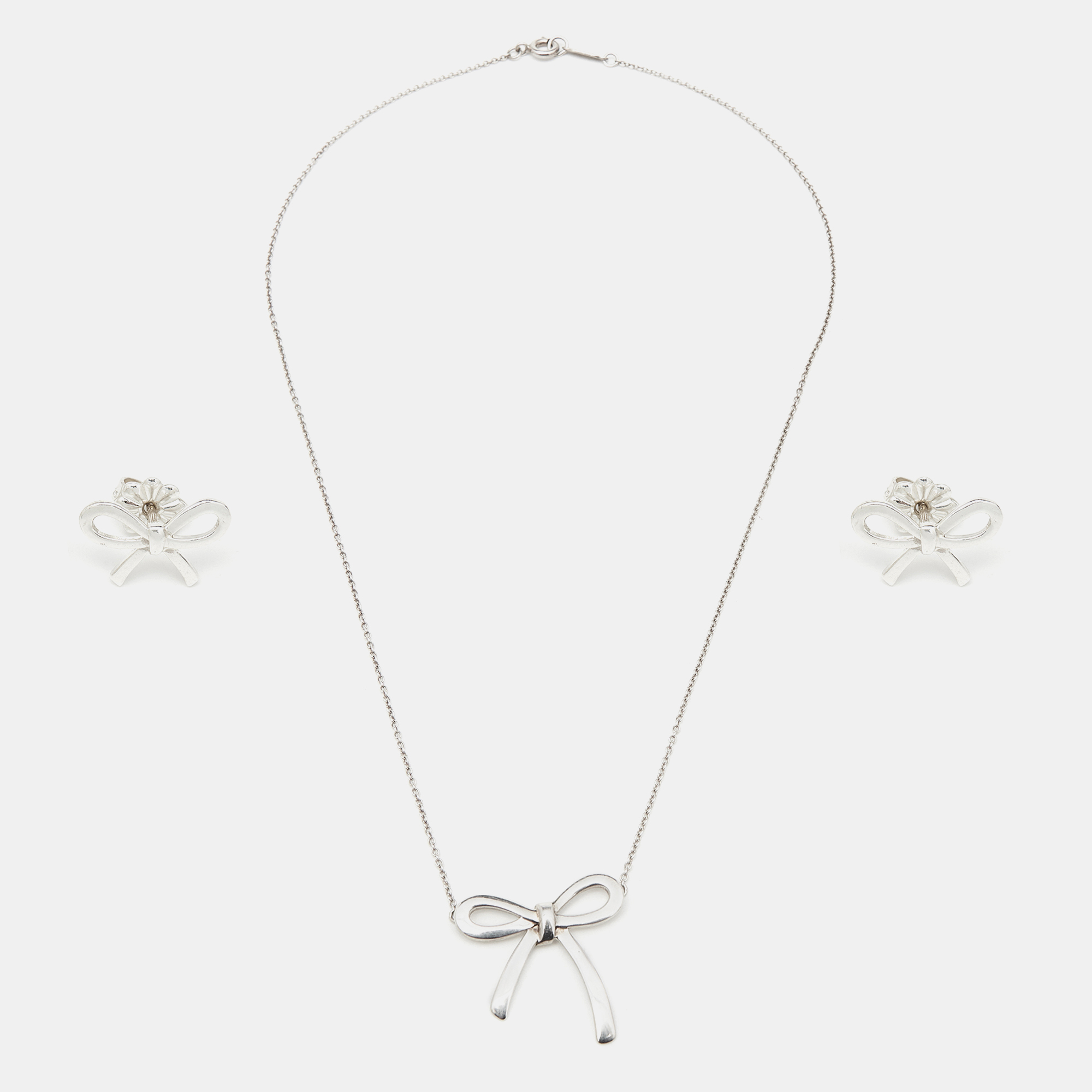 

Tiffany & Co. Bow Sterling Silver Pendant Necklace And Earrings