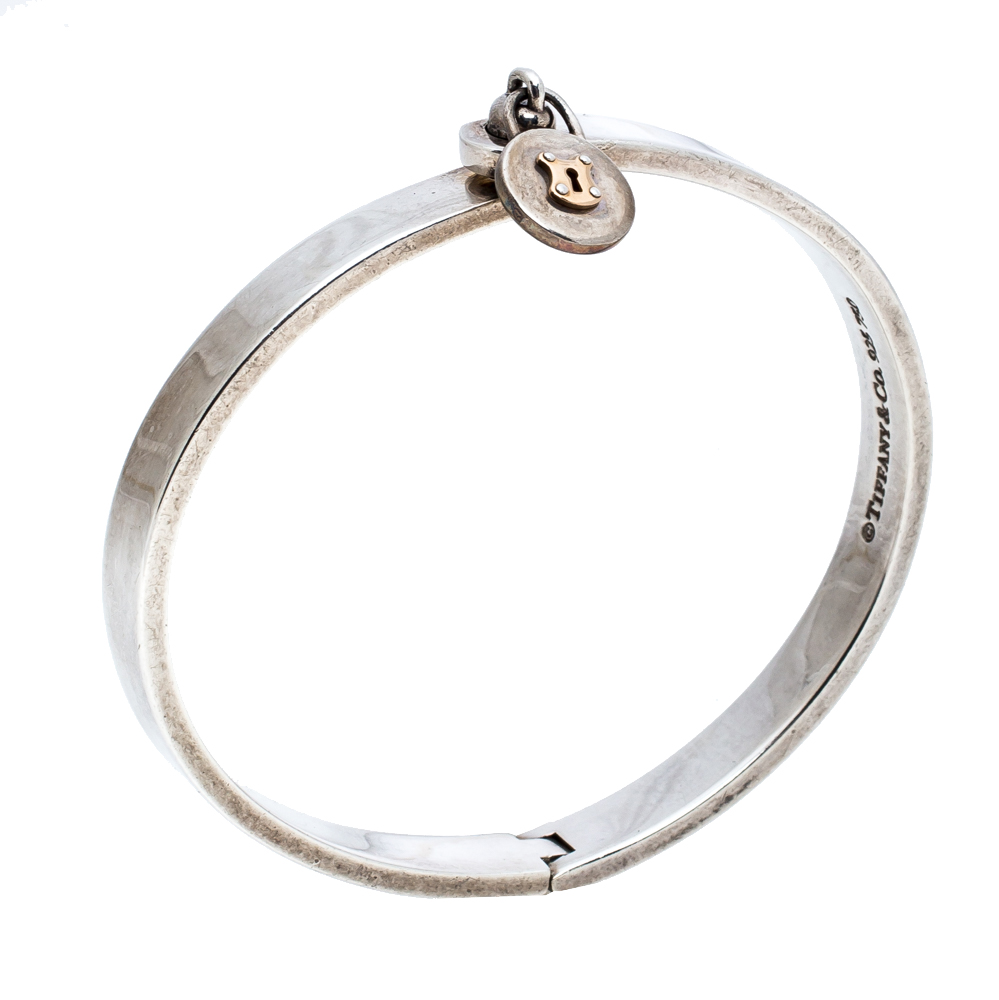 

Tiffany & Co. Silver 18K Gold Round Lock Charm Bangle Bracelet