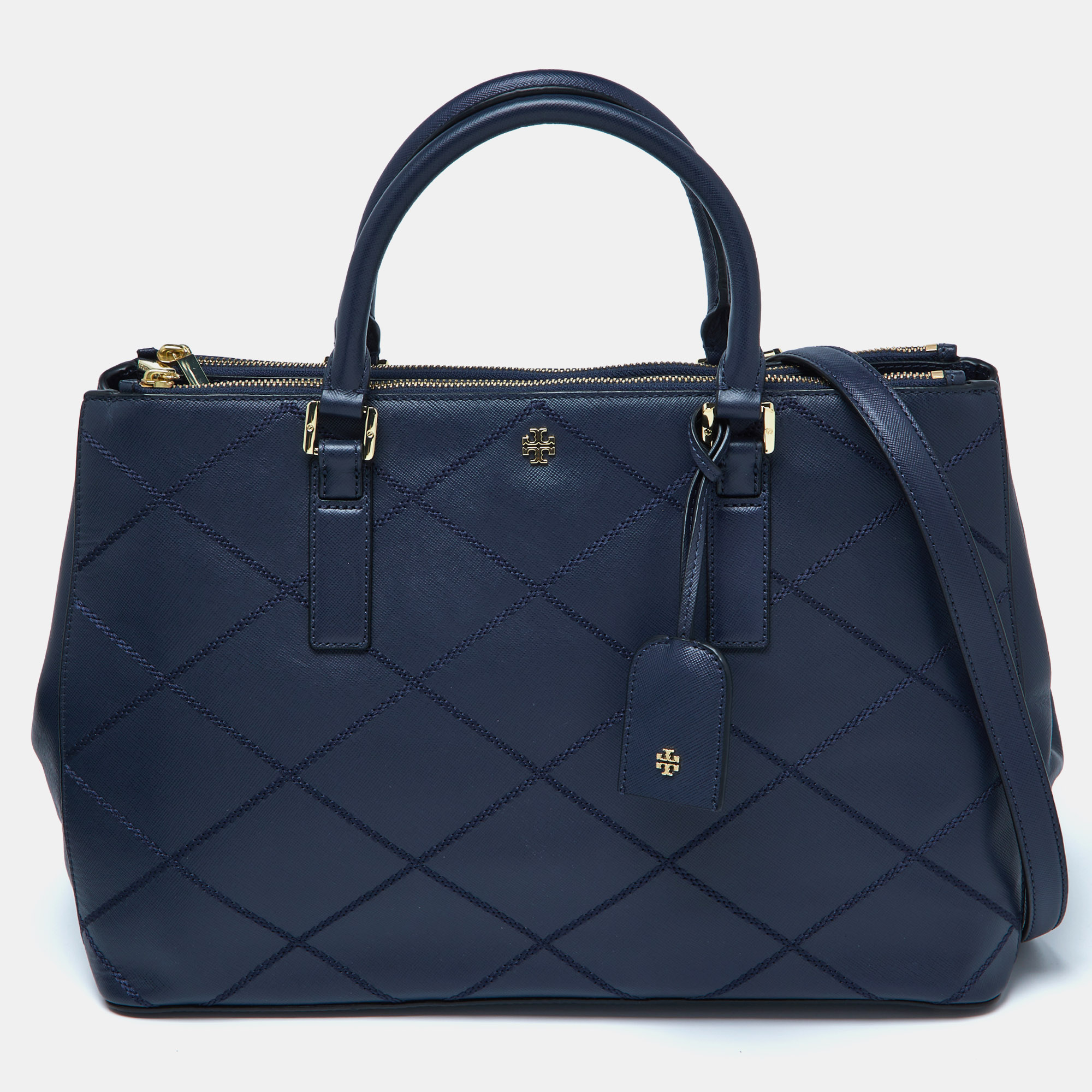 This Tory Burch leather tote has been expertly crafted with wild stitch details. Lined with fabric and leather the roomy interior has an ample amount of space to keep your belongings safe. While the dual handles make it comfortable to carry the brand logo on the front gives the bag a luxe finish.