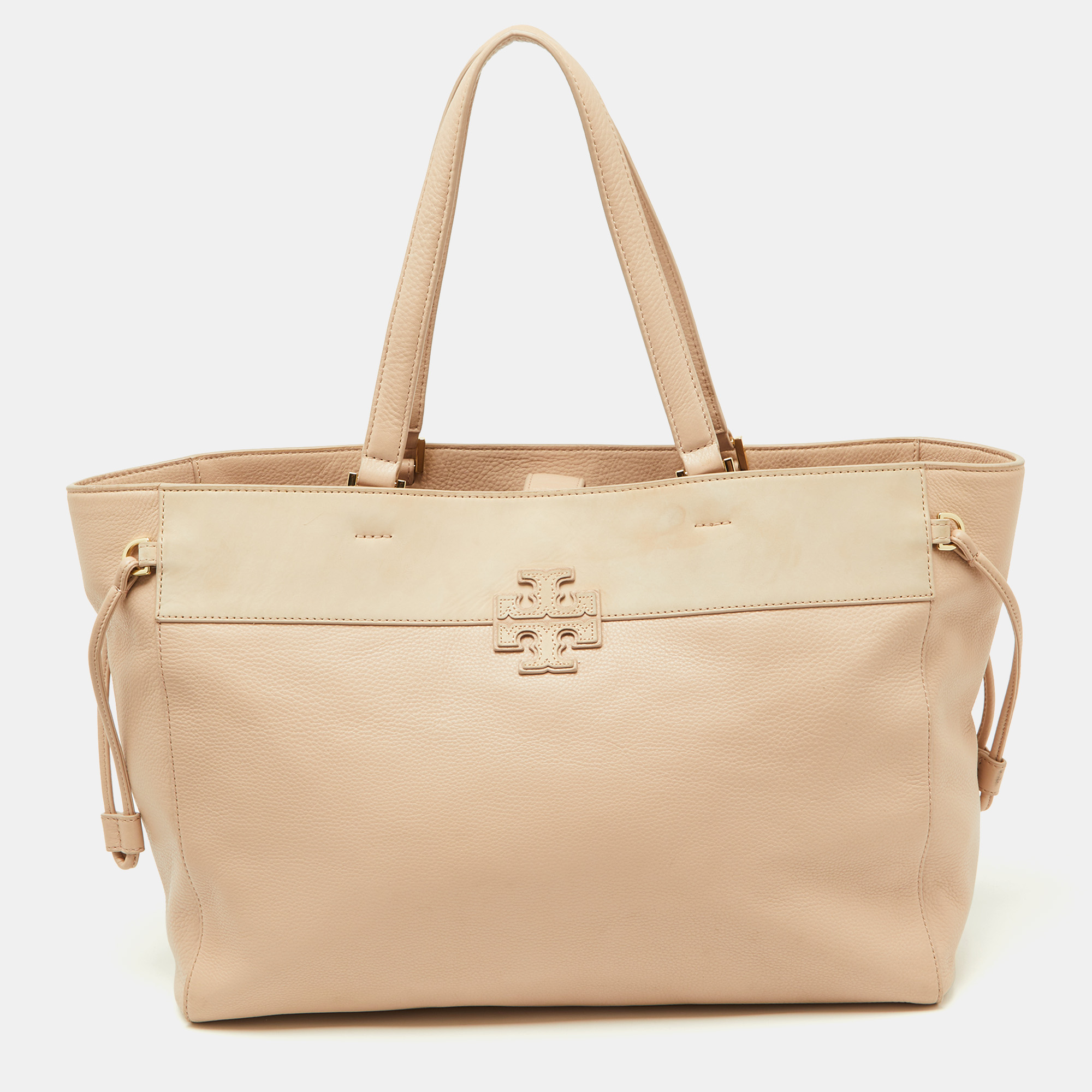 Known for its high standard and fine finish this handbag from Tory Burch will be your companion for years to come. This tote is carefully created from genuine leather and the brand label at the front. An epitome of fashion this beautifully crafted bag comes with a highly durable canvas interior. Add some sophistication to your ensemble with this high class handbag in pink and beige.