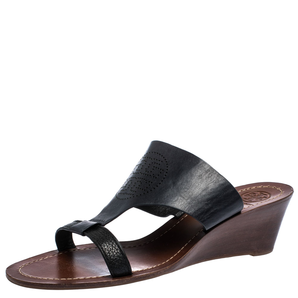 Flaunt these fabulous sandals from Tory Burch and step out in style. These trendy black sandals are versatile and can be worn on any occasion. Crafted from leather they are styled with open toes perforated logo detail on the vamps wedge heels and rubber soles.