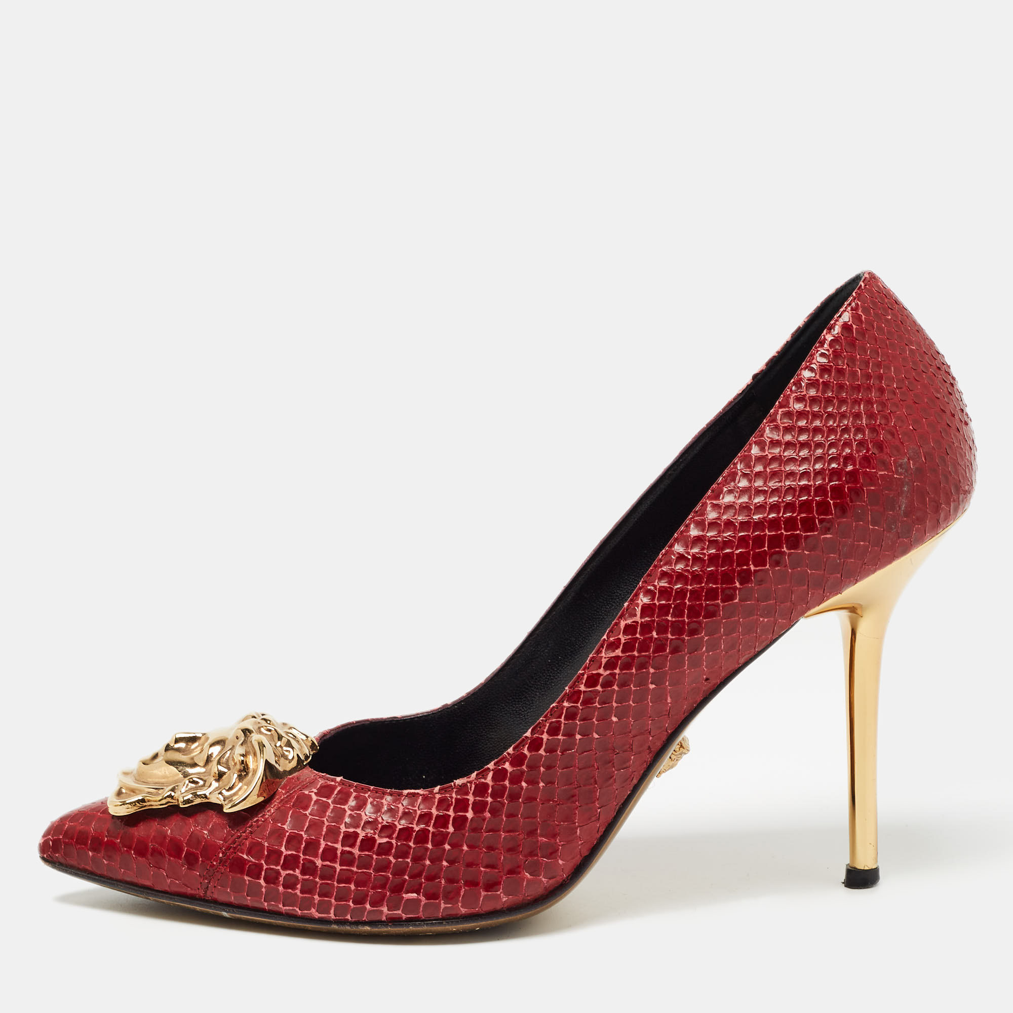 This pair of Versace pumps are a style statement with a timeless design. Crafted from python leather they feature pointed toes accented with the iconic Medusa motif in gold tone metal 10cm heels and leather soles. They bring a touch of glamour to every outfit they are paired with.