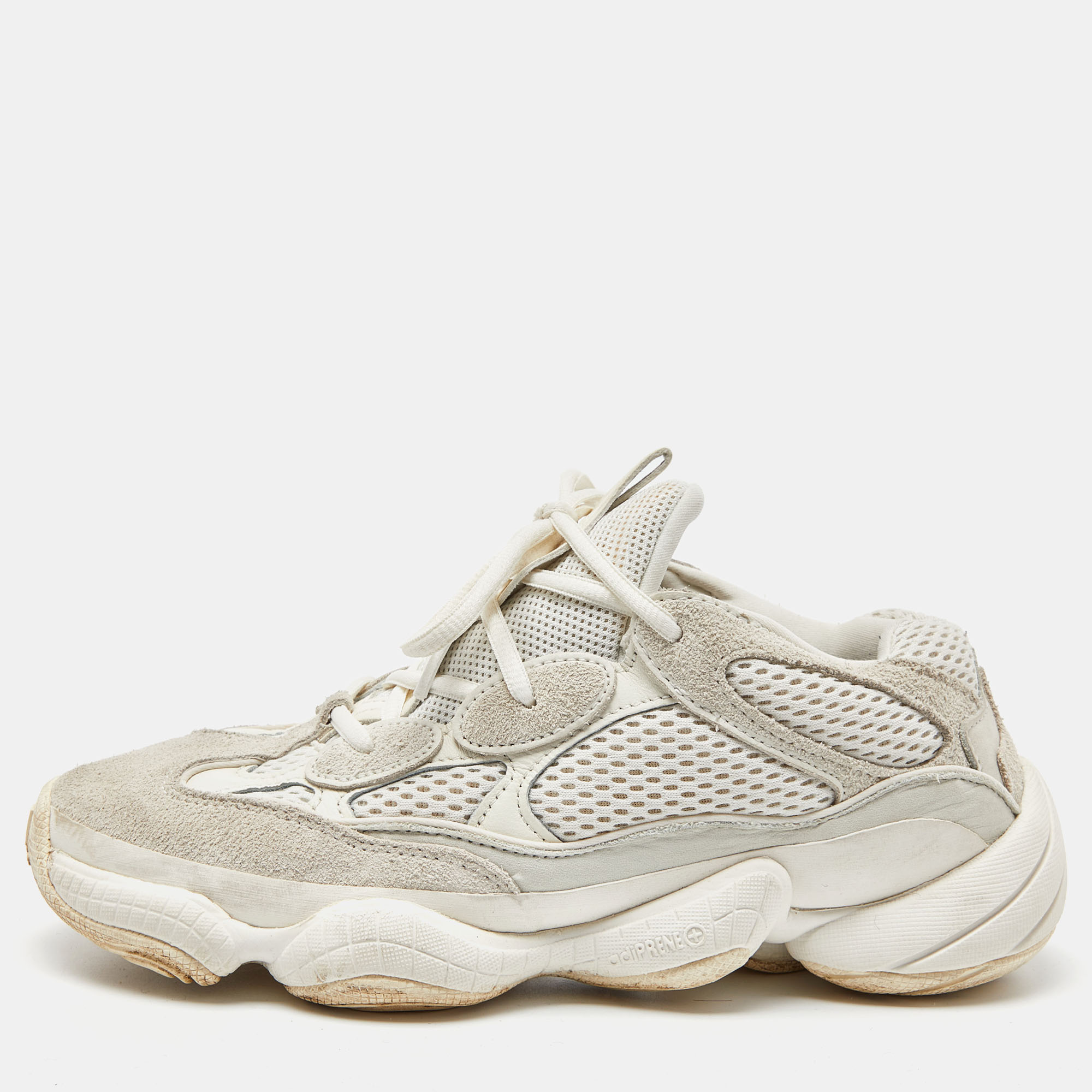 The Yeezy x adidas Yeezy 500 sneakers combine premium materials to create a stylish and comfortable footwear option. The shoe features a sleek white suede upper with mesh accents while the distinctive chunky sole offers excellent support and cushioning for everyday wear with a touch of urban flair.