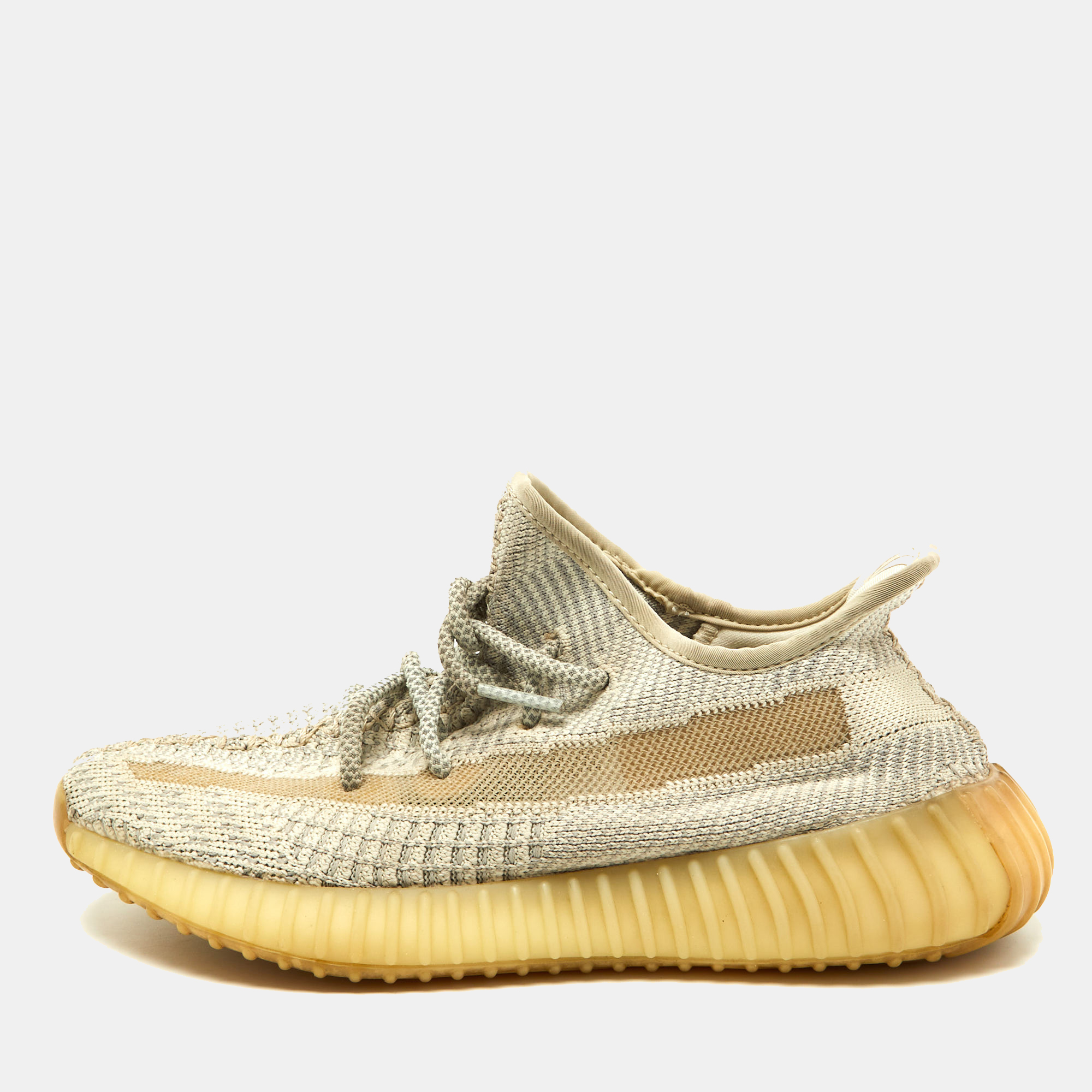 Catch on with the trend of designs from the Yeezy x Adidas collaboration with this pair of Boost 350 V2 sneakers. The knit fabric pair features great cushioning lace ups on the vamps and tough rubber soles. This pair comes in beige with the signature stripe detailing on the side.